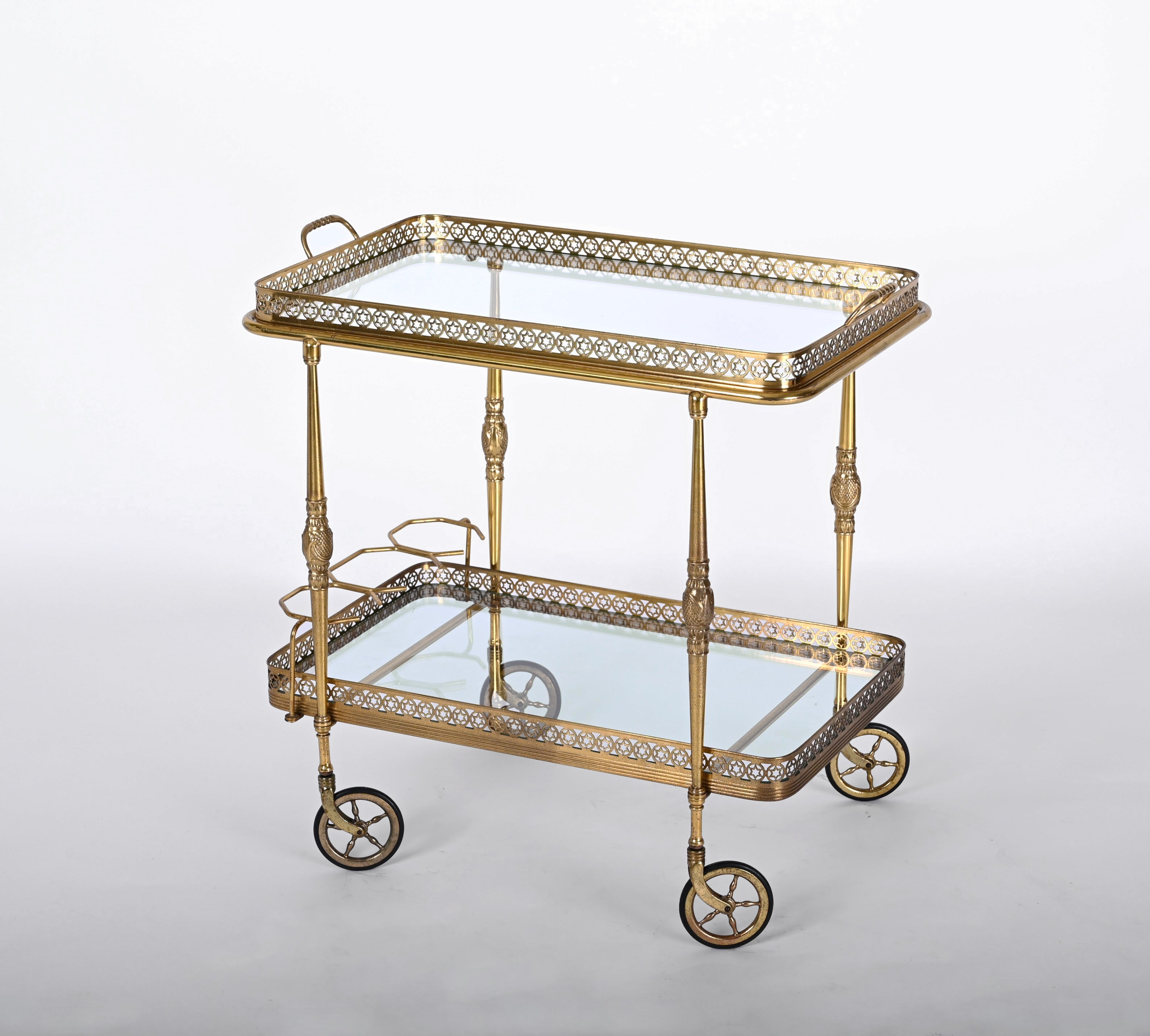 Magnificent brass and crystal glass serving bar trolley with two levels. This serving trolley was produced by Maison Baguès in France during 1950s.

The structure of this unique piece is made in fully carved brass with stunning hand made sun
