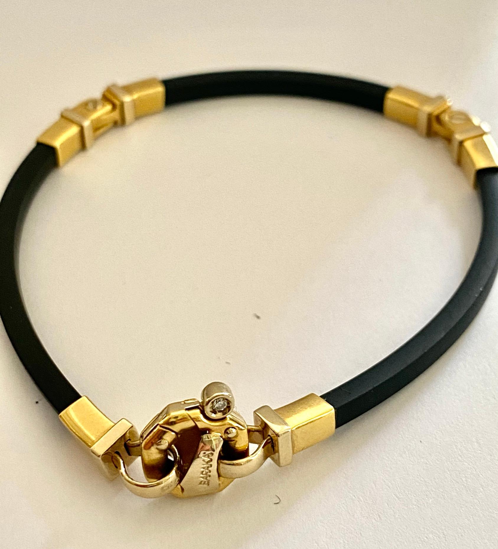 One (1) 18K. yellow gold with 3 pieces of black rubber bracelet.
signed: BARAKA, Italy
length: 19 cm. (7.4 inch)
wide gold: 0.4 cm (0.2 inch) wide rubber: 0.25 cm (0.15 inch)
Total weight: 12.83 grams