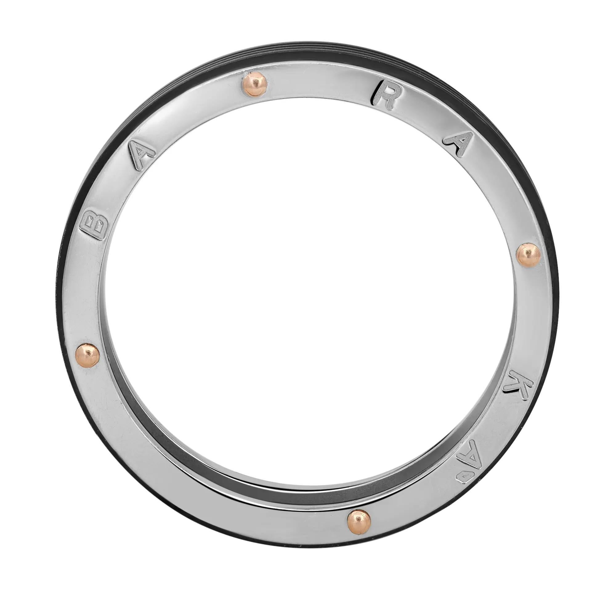This stylish men's wedding band ring is lovingly fabricated in smooth 18K white gold with rose gold accents, steel and black PVD. Ring size: 14. Ring width: 6.4mm. This ring is a store display model and does not come with the original box and