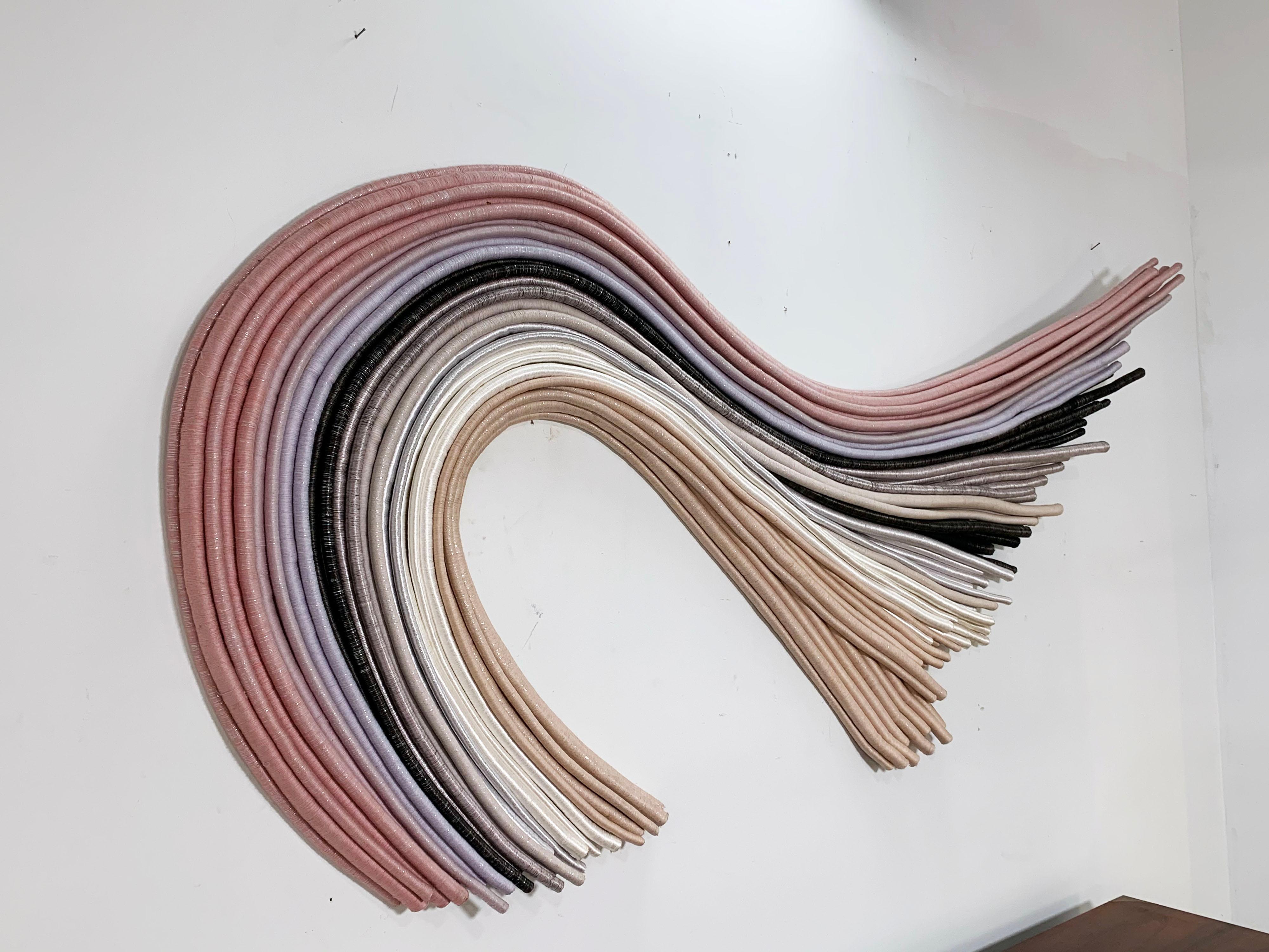 Oversized, 8 foot long wall-mounted fiber art sculpture by textile artist Barbara Barron, circa 1980s. Barron is a noted artist whose works are readily recognizable from her technique of wrapping fibers into tube like rods. She is also an
