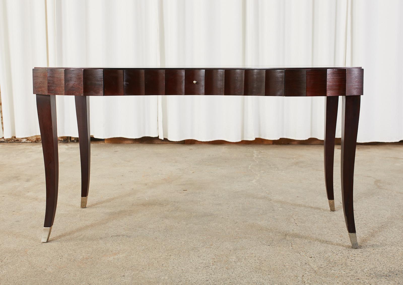 Glamorous Art Deco style writing table or desk designed by Barbara Barry for Baker Furniture. Crafted from oak hardwood featuring a sleek case with dramatic scalloped edges on each side and a serpentine shaped front. There is a single storage drawer