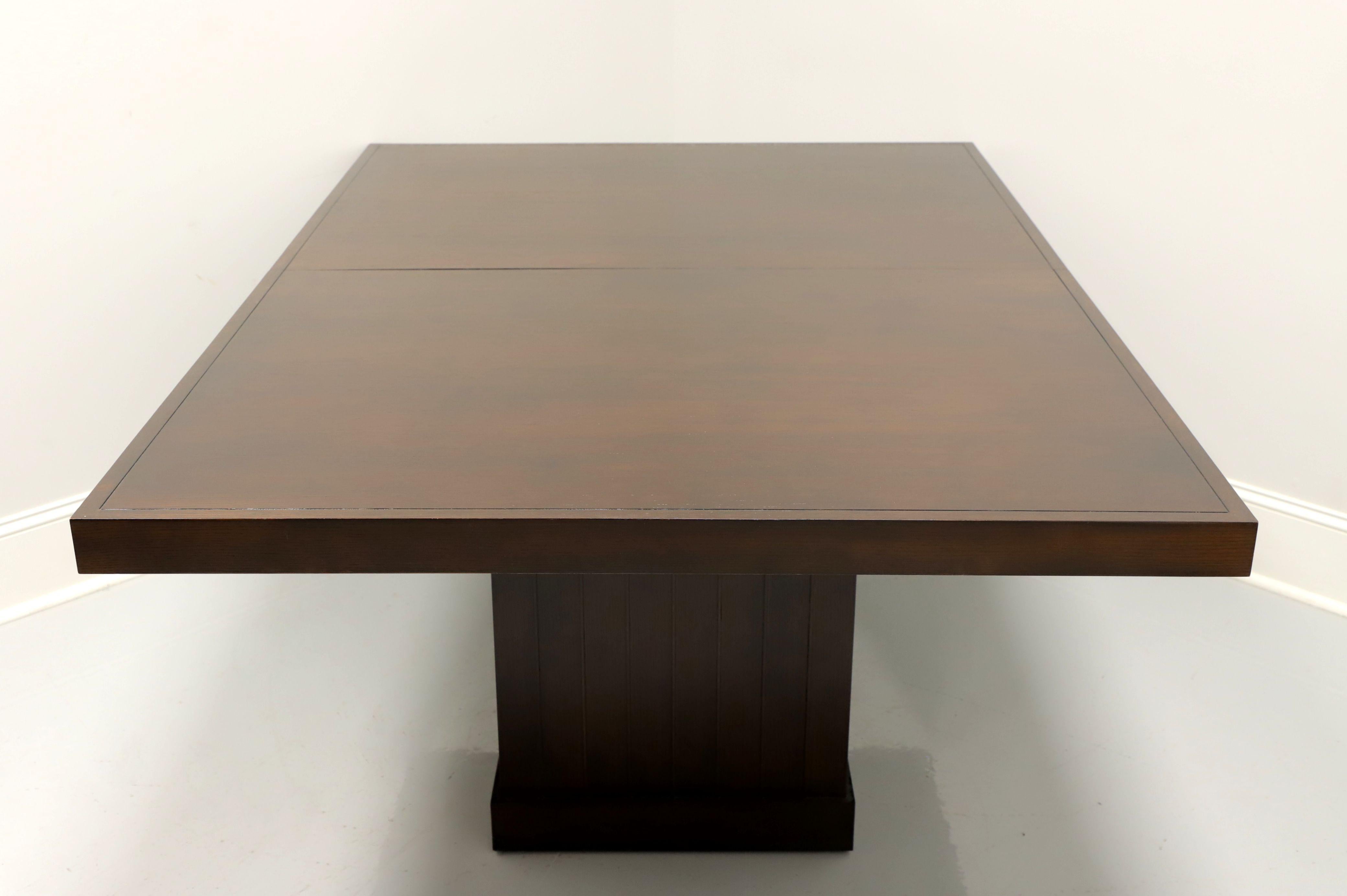 A Contemporary style rectangular dining table by Barbara Barry for Baker Furniture. Solid mahogany, having an architectural nod with a rectangular top, board banding/apron and a solid rectangular pedestal base with the look of slats and a baseboard.