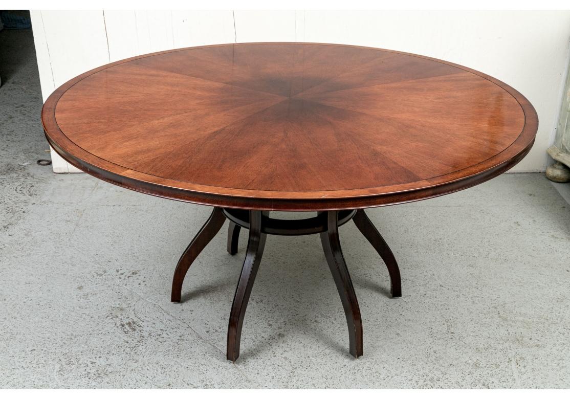 A Baker Furniture round dining table with cross banding in a rich mahogany color resting on six spider legs conjoined with a circular stretcher. Designed by Barbara Barry for Baker Furniture.

Dimensions: 60