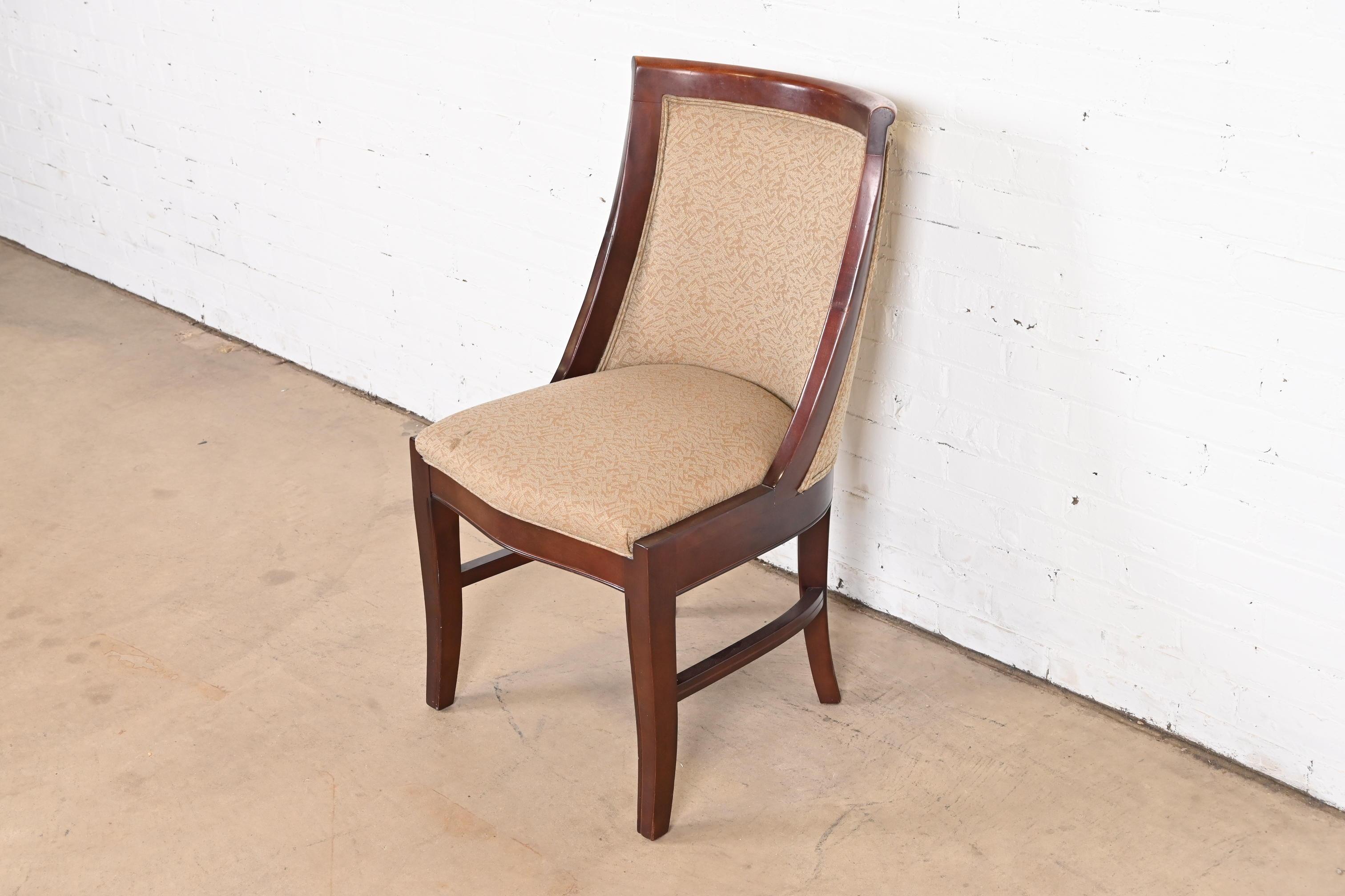 A gorgeous modern Art Deco style upholstered side chair or desk chair

Attributed to Barbara Barry for Baker Furniture

USA, circa 1990s

Carved mahogany frame, with upholstered seat and back.

Measures: 20