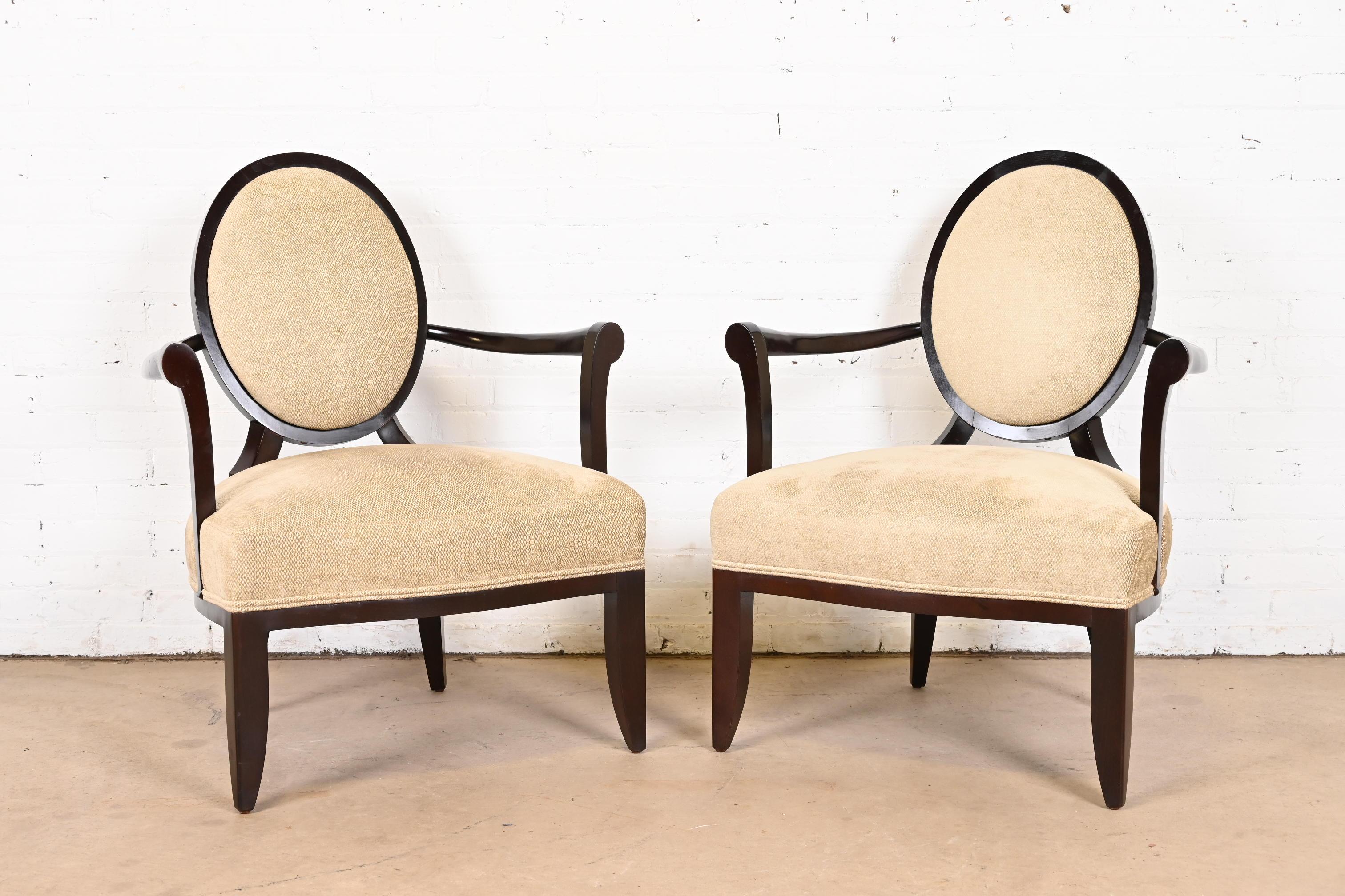 A gorgeous pair of Modern oval x-back club chairs or lounge chairs

By Barbara Barry for Baker Furniture

USA, Circa 1990s

Carved mahogany frames, with tan upholstery.

Measures: 29.5