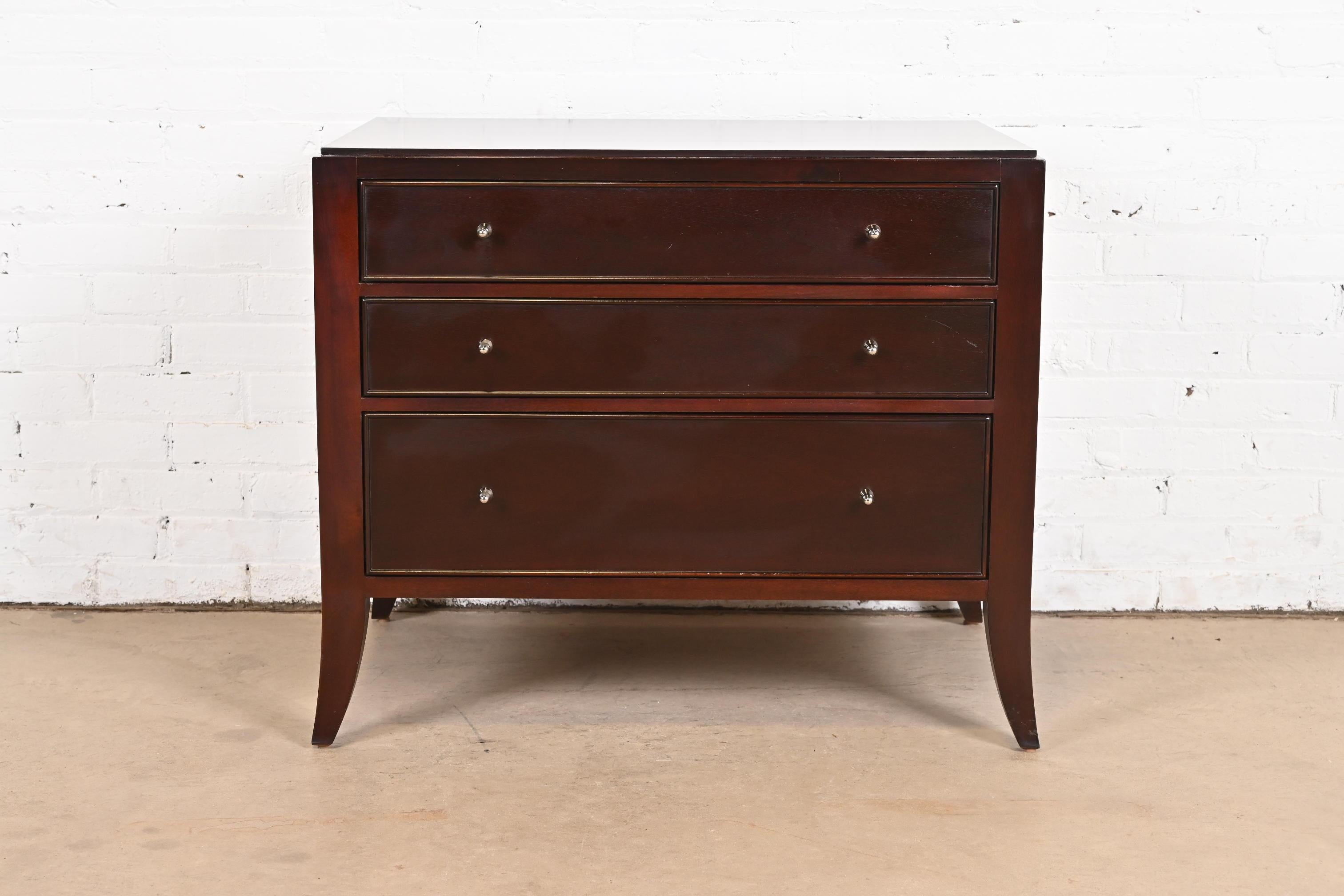 An exceptional Modern Regency style three-drawer nightstand or bachelor chest

By Barbara Barry for Baker Furniture

USA, Circa 1990s

Dark mahogany, with original nickel hardware.

Measures: 32
