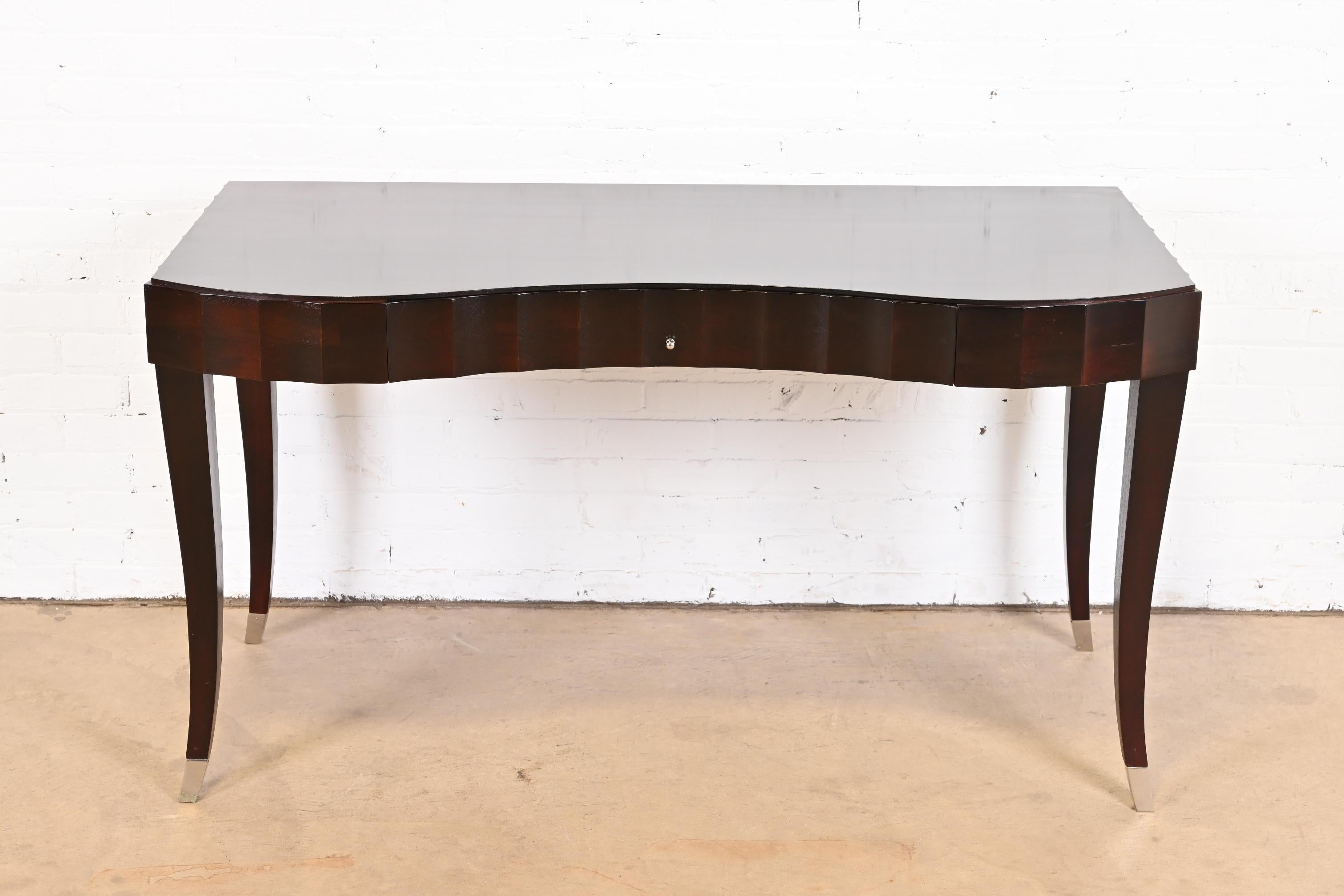 A gorgeous Modern Art Deco style dark mahogany writing desk, vanity, or console table with custom glass top

By Barbara Barry for Baker Furniture

USA, Circa 1990s

Measures: 54
