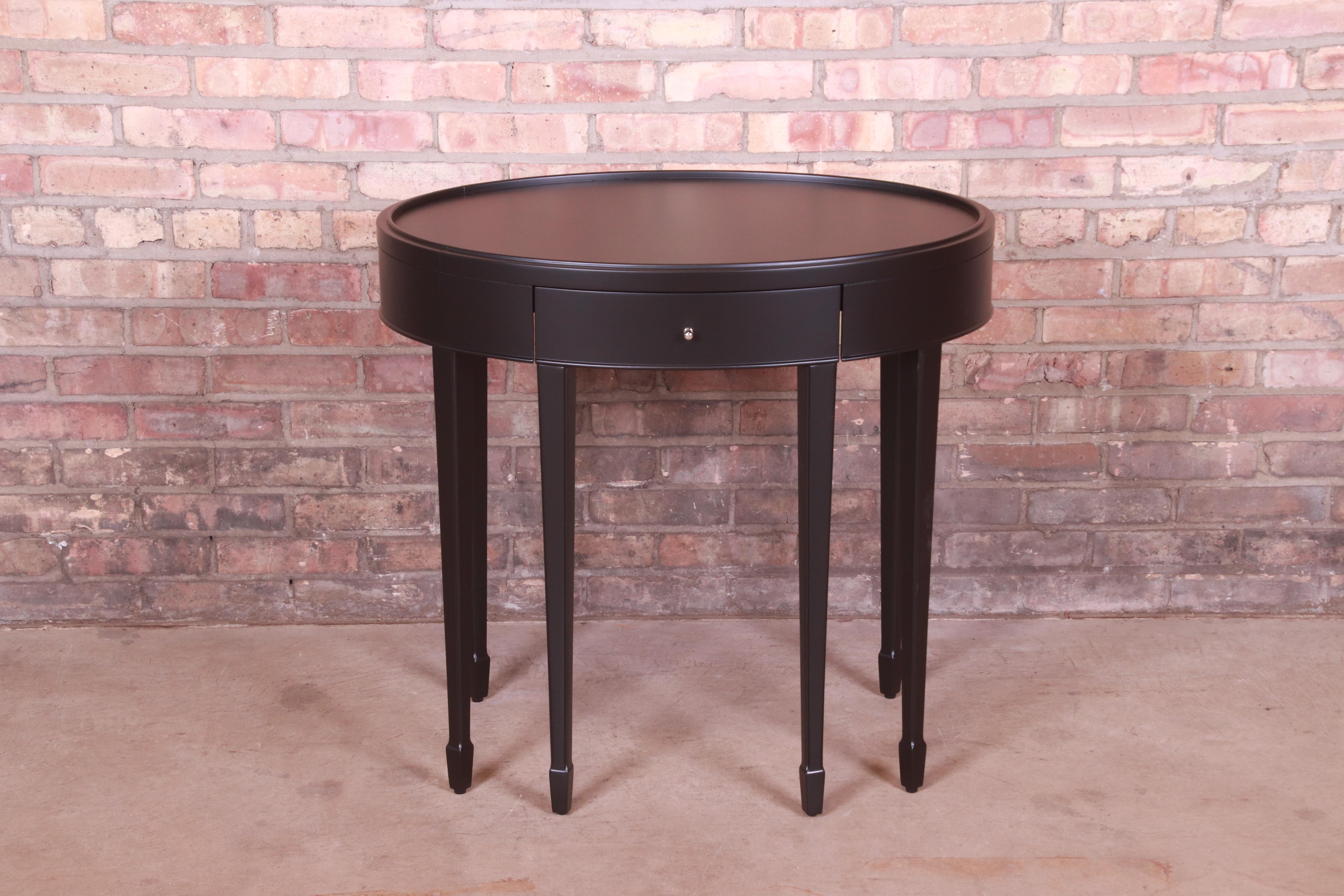 An elegant modern tea table or occasional side table

By Barbara Barry for Baker Furniture

USA, Circa 1990s

Black lacquered mahogany, with nickel hardware.

Measures: 30