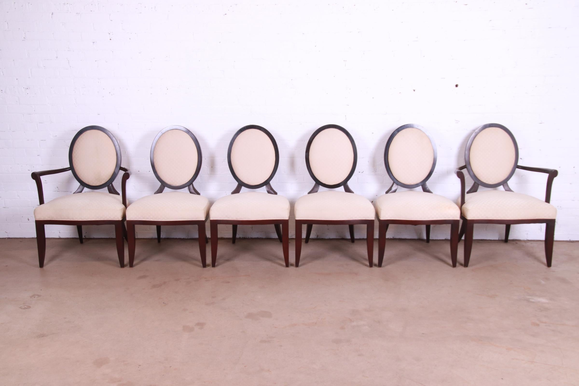 A gorgeous set of six modern Neoclassical style oval back dining chairs

By Barbara Barry for Baker Furniture

USA, Circa 1990s

Sculpted mahogany, with ivory upholstered seats and backs.

Measures:
Side chairs - 23