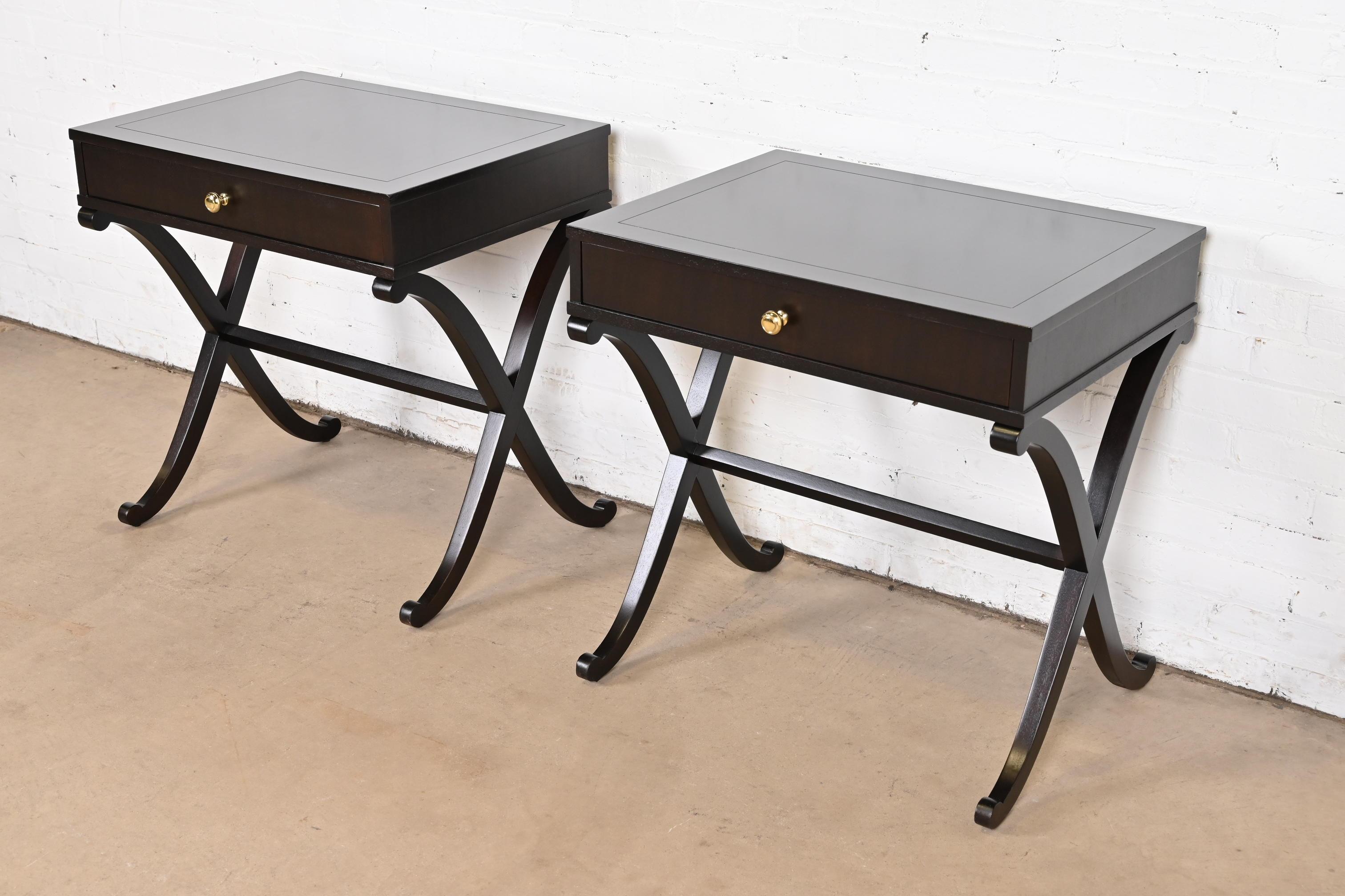 A gorgeous pair of modern Regency or Art Deco style tea tables, console sofa tables, or bedside tables

By Barbara Barry for Baker Furniture

USA, Circa 1990s

Dark mahogany, with brass hardware.

Measures: 27