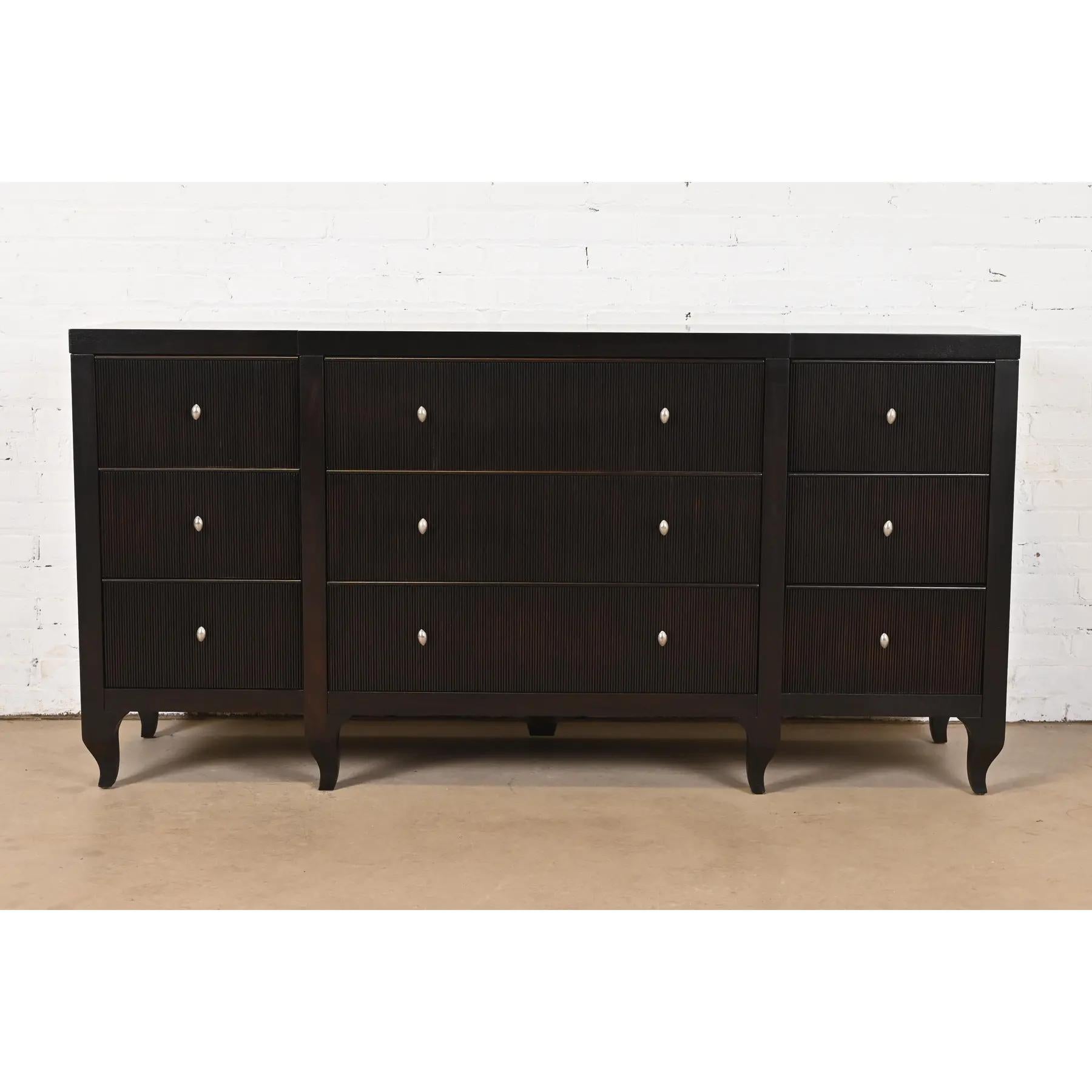 An exceptional Modern Regency dark mahogany triple dresser or credenza

By Barbara Barry for Baker Furniture

USA, Circa 1990s

Dark mahogany, with unique vertical fluted design drawer fronts, and original nickel hardware.

Measures: 68.13