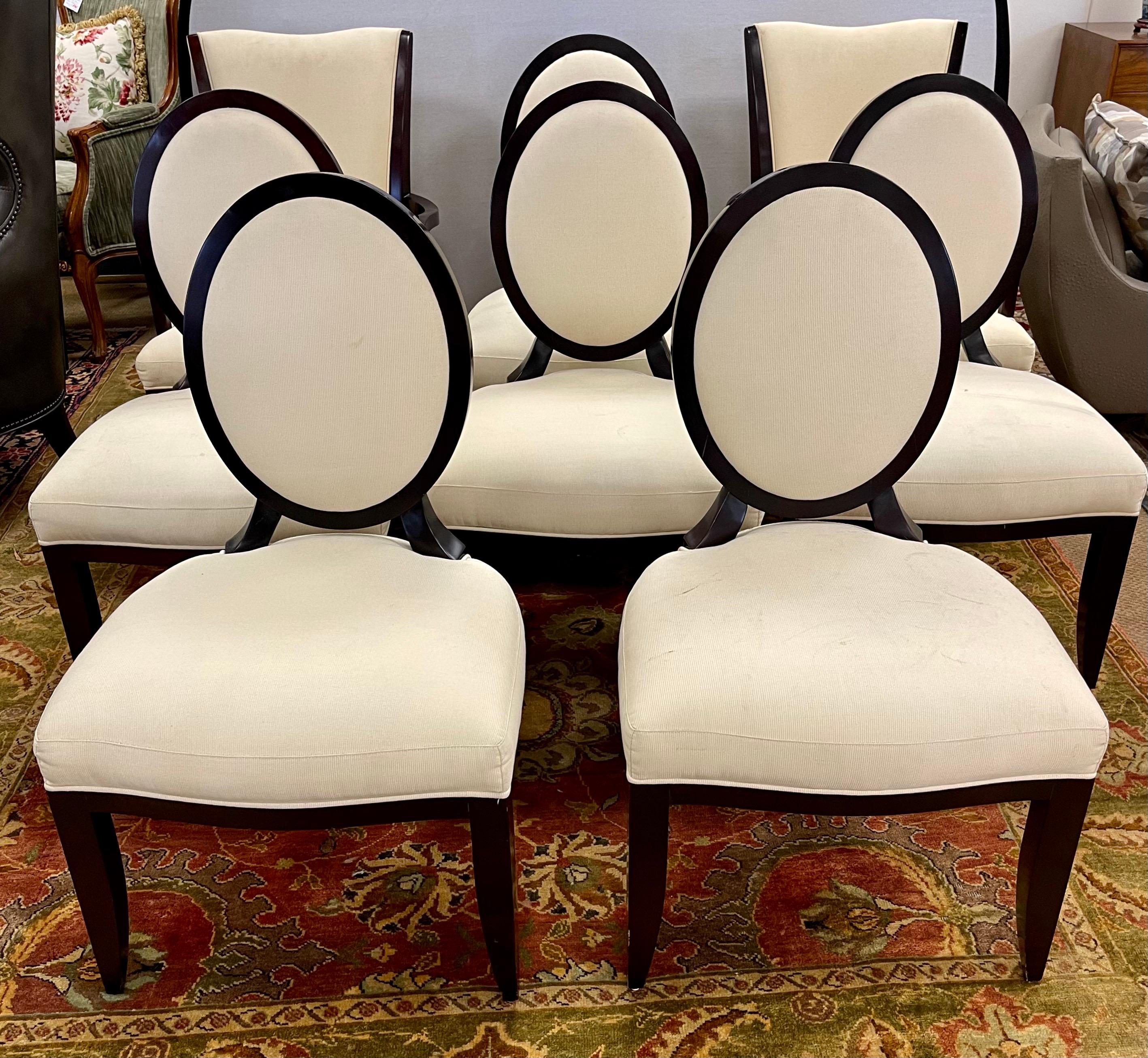 Elegant and coveted set of Baker Furniture dinging chairs designed by Barbara Barry. All hallmarks on bottom. Note there are six oval back side chairs and to arm chairs to round out the set. There is some wear to the mahogany wood and the fabric on