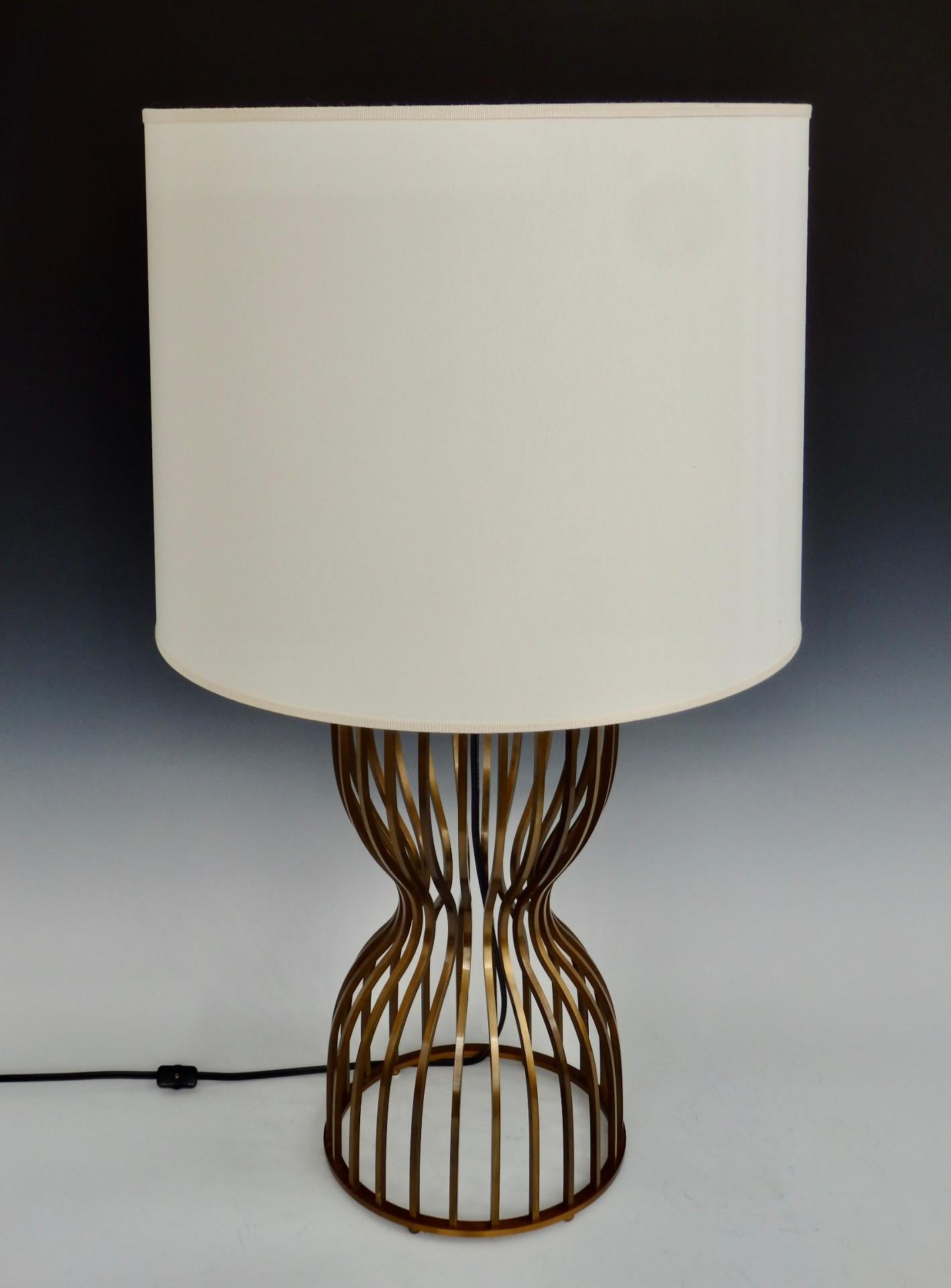 Nicely machined brass components form hour glass or dress form base. Designed by Barbara Barry. Machined and assembled in Italy for Baker furniture. Lamp has 9.75