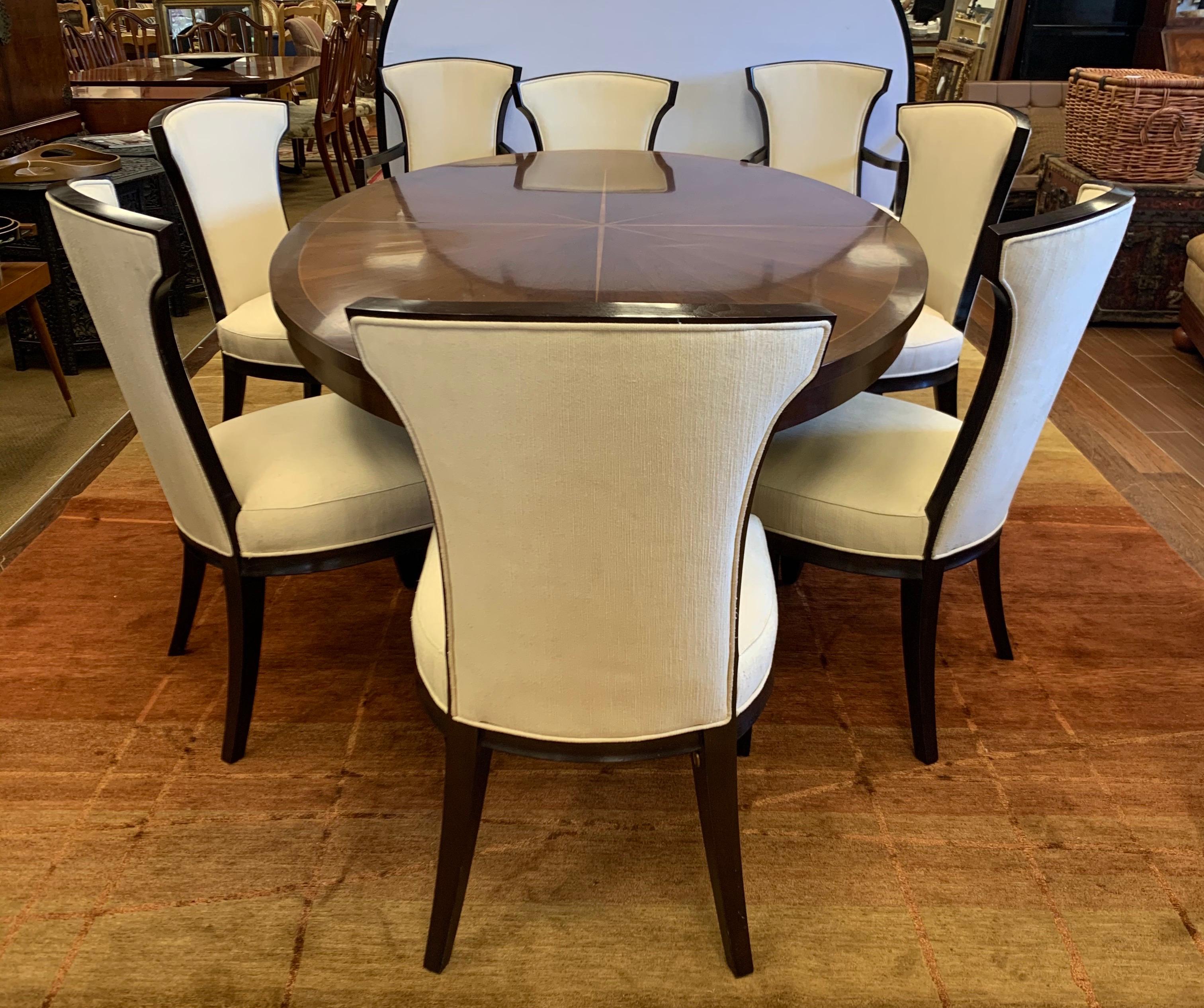 A stunning Barbara Barry for Henredon furniture celestial walnut oval dining table and matching chairs. Barry's unflinching eye towards craftsmanship and quality have made her furniture design for Henredon and Baker coveted throughout the world. The