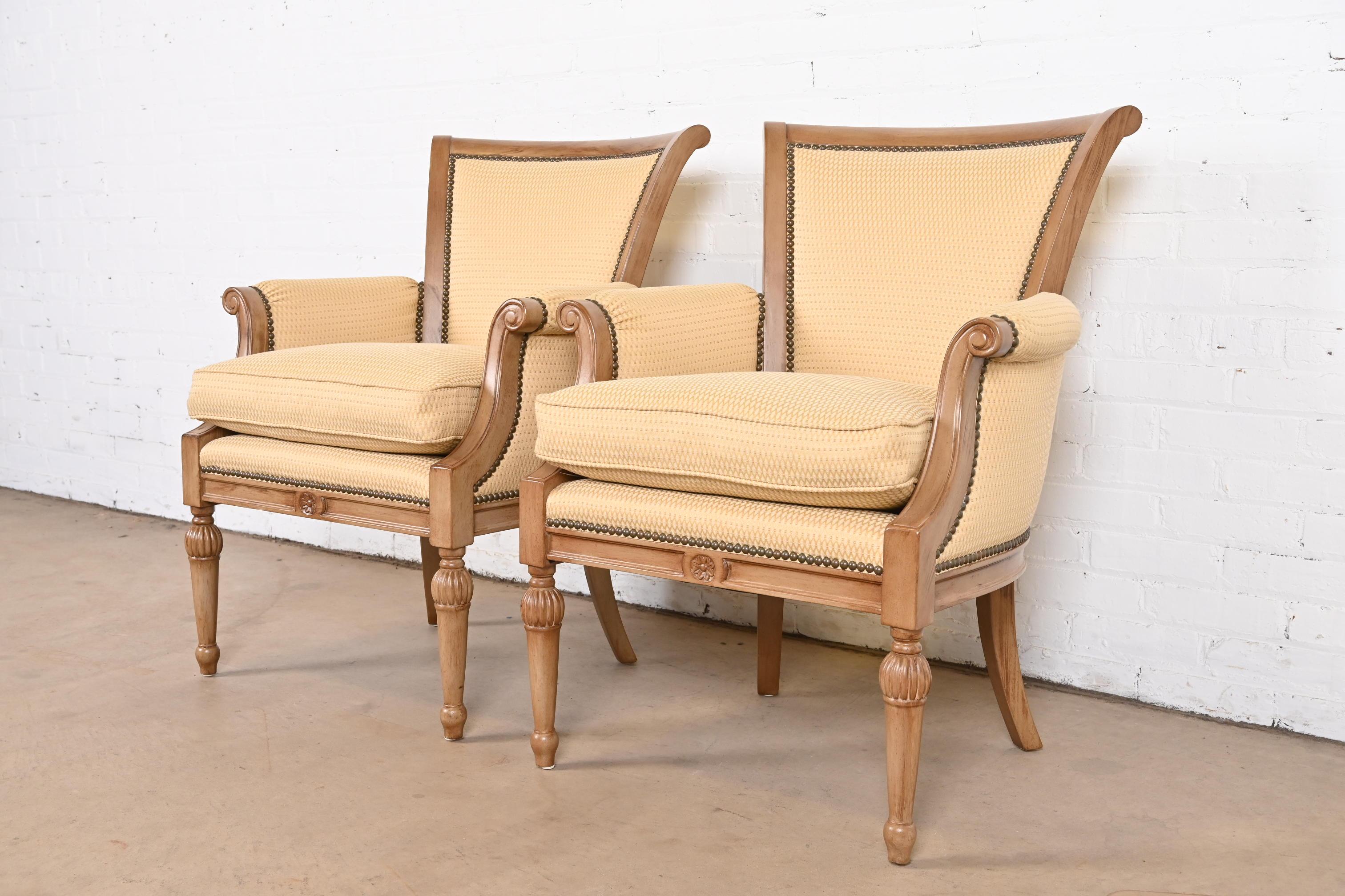 A gorgeous pair of French Regency Louis XVI style upholstered club chairs or bergere chairs

By Barbara Barry for Henredon

USA, Circa 1990s

Carved walnut frames, with studded upholstery.

Measures: 27