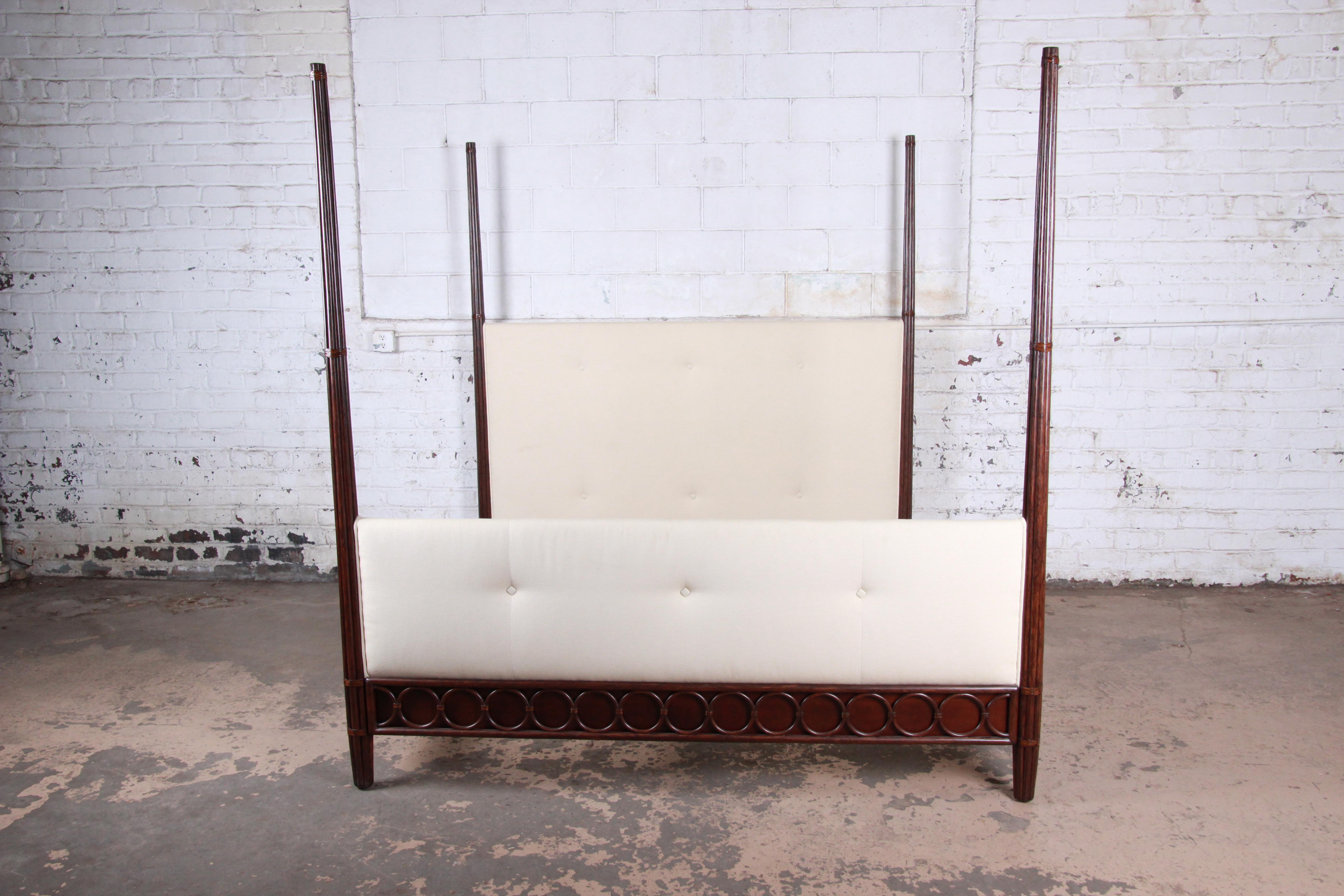 An exceptional rattan and mahogany king size poster bed by Barbara Barry for McGuire of San Francisco. The bed features a gorgeous solid mahogany frame with bent rattan accent rings. The headboard and footboard are upholstered in a beautiful tufted
