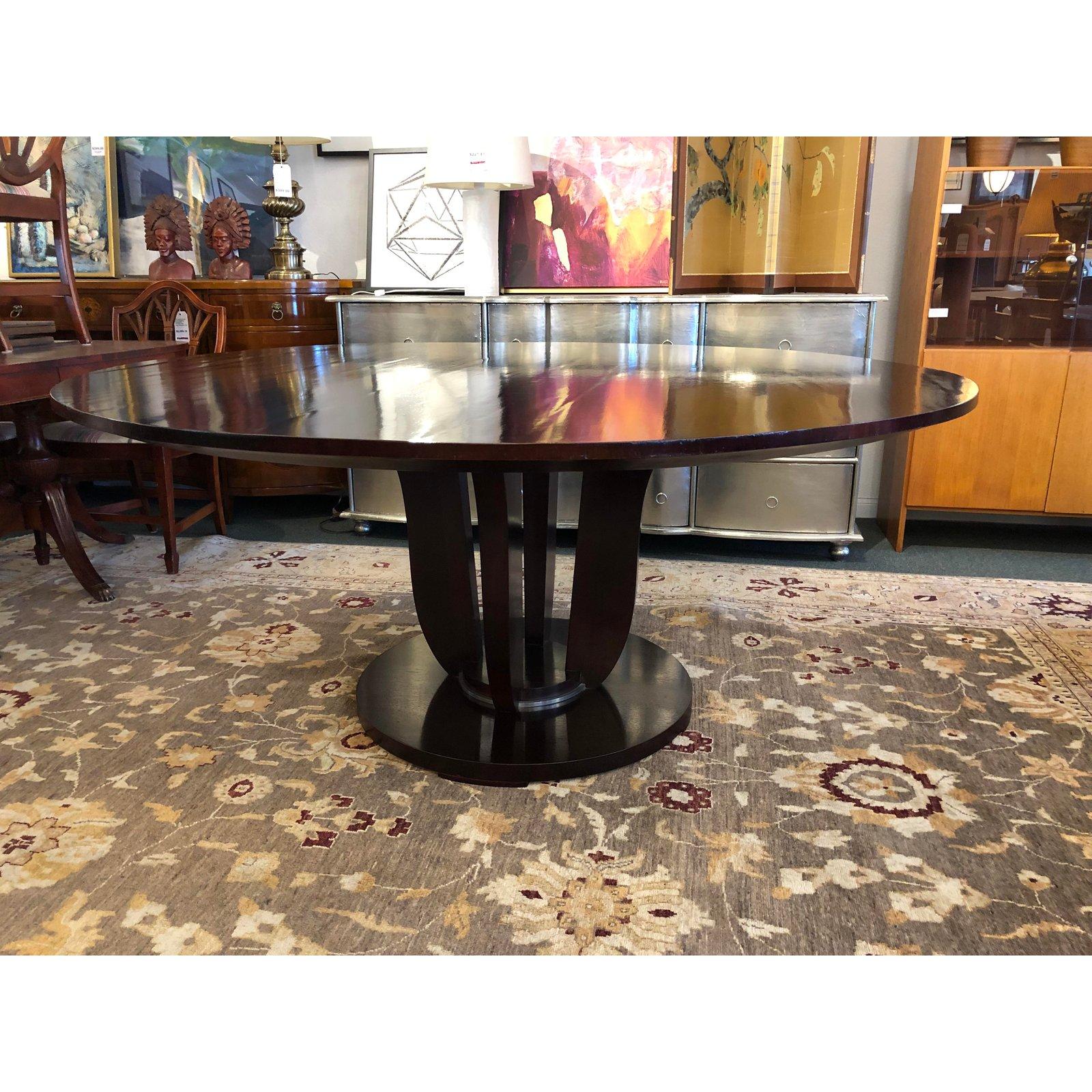 We presents the gueridon dining table by Baker Furniture. Barbara Barry took her design inspiration for this elegant table from the 1930s. Designed to allow for comfortable dining, the mahogany pedestal table has a deep underside bevel plus a tiny