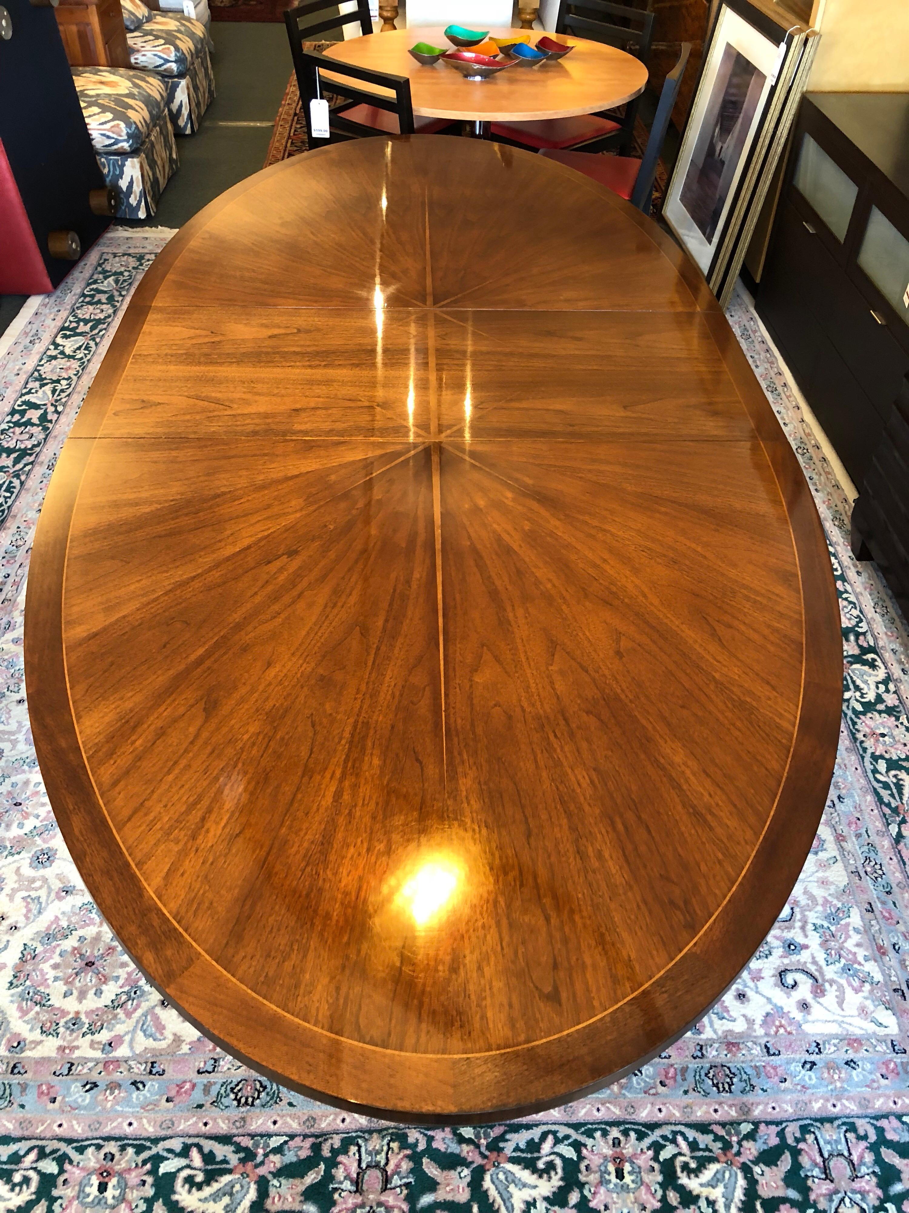 A gorgeous 'Celestial' sunburst oval dining table by Barbara Berry for Henredon. The sunburst wood grain pattern and delicate insignia is expertly extended with the addition of the table leaf, maintaining the symmetry of the radiant design. A solid