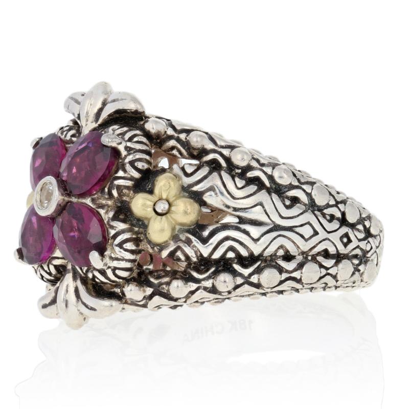 Turn heads your way when you accessorize with this stunning designer ring! Created by Barbara Bixby in sterling silver with accents of 18k yellow gold, the ring showcases a genuine white topaz solitaire and four natural Rhodolite garnets. Textured