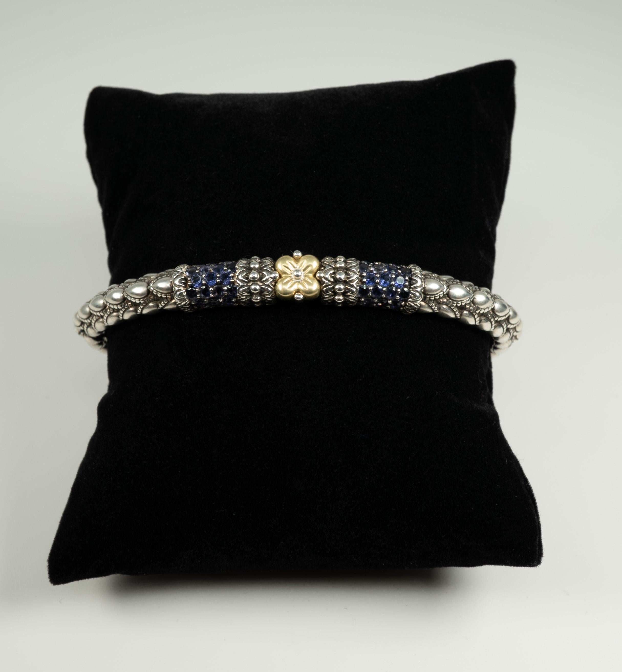 In sterling silver, with 18 karat yellow gold and iolite accents and a stainless steel hinge, this fun cuff is very light on the wrist! 