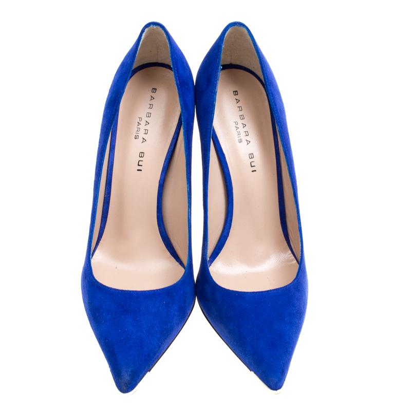 Strike the right pose with these marvelous pumps from Barbara Bui. They've been crafted from cobalt blue suede and styled with metal accents on the pointed toes, leather insoles, and block heels for the ultimate lift of confidence. They'll look