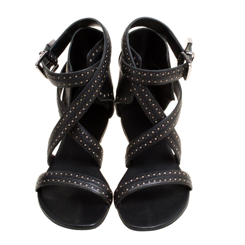 These sandals from Barbara Bui look gorgeous! They are crafted from leather and designed with perforated accents, laser cuts and straps that end as cuffs around the ankles. This lovely black pair will have everyone in admiration.

Includes: Original