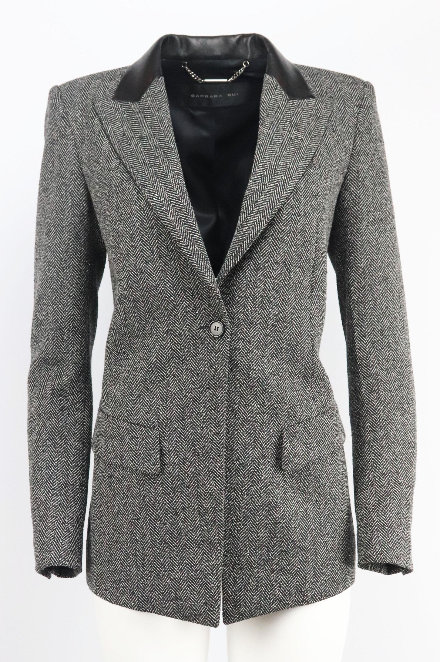 This blazer by Barbara Bui really highlights the designer's impeccable tailoring skills, cut from herringbone wool-blend, it has a structured silhouette with padded shoulders and sharp leather-trimmed peak lapels to add a big of edge.
Black and grey
