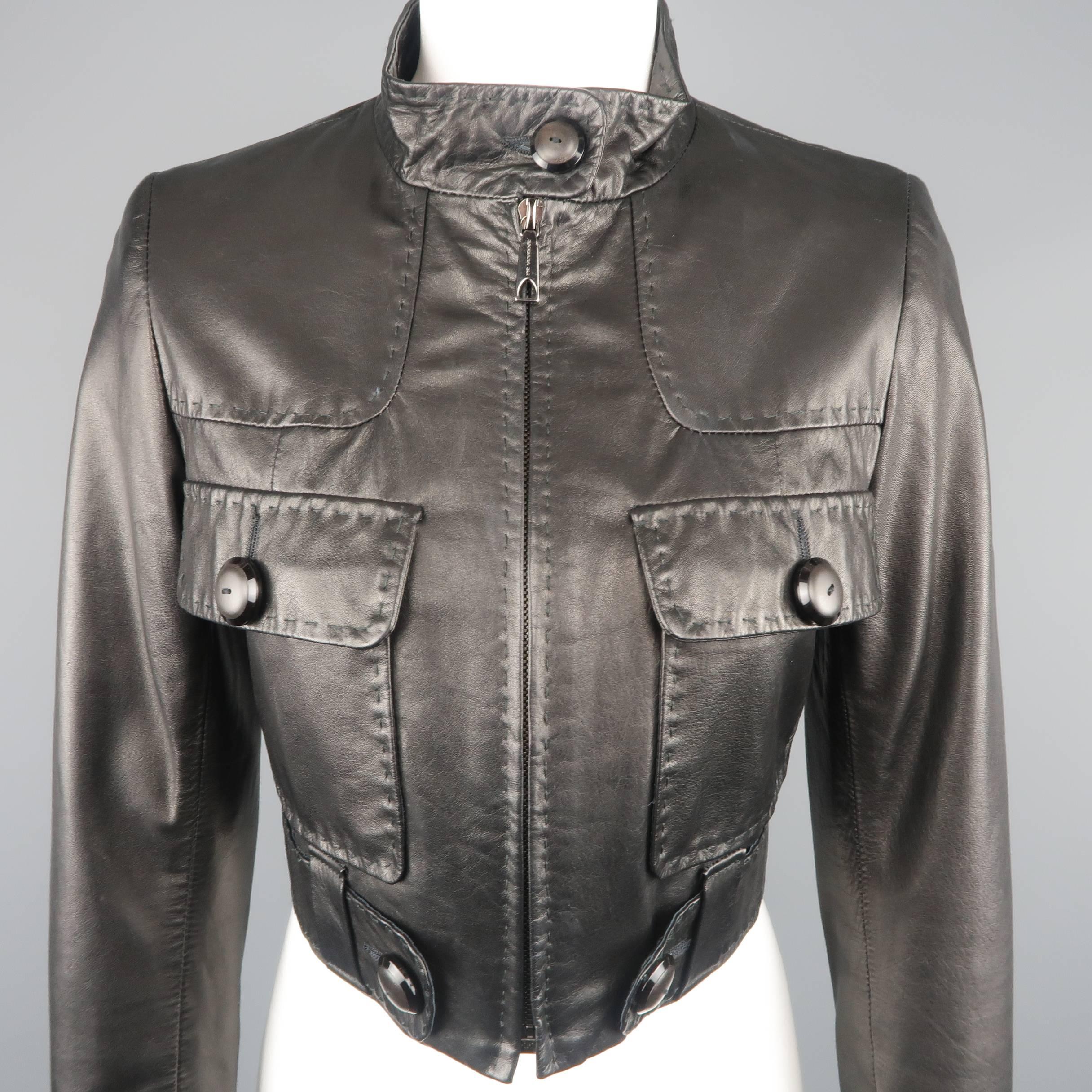 BARBARA BUI cropped bomber jacket comes in smooth black leather with a stand up button collar, patch flap pockets, tab belt, and top stitching throughout. Minor wear.
 
Good Pre-Owned Condition.
Marked: EU 36
 
Measurements:
 
Shoulder: 14 in.
Bust: