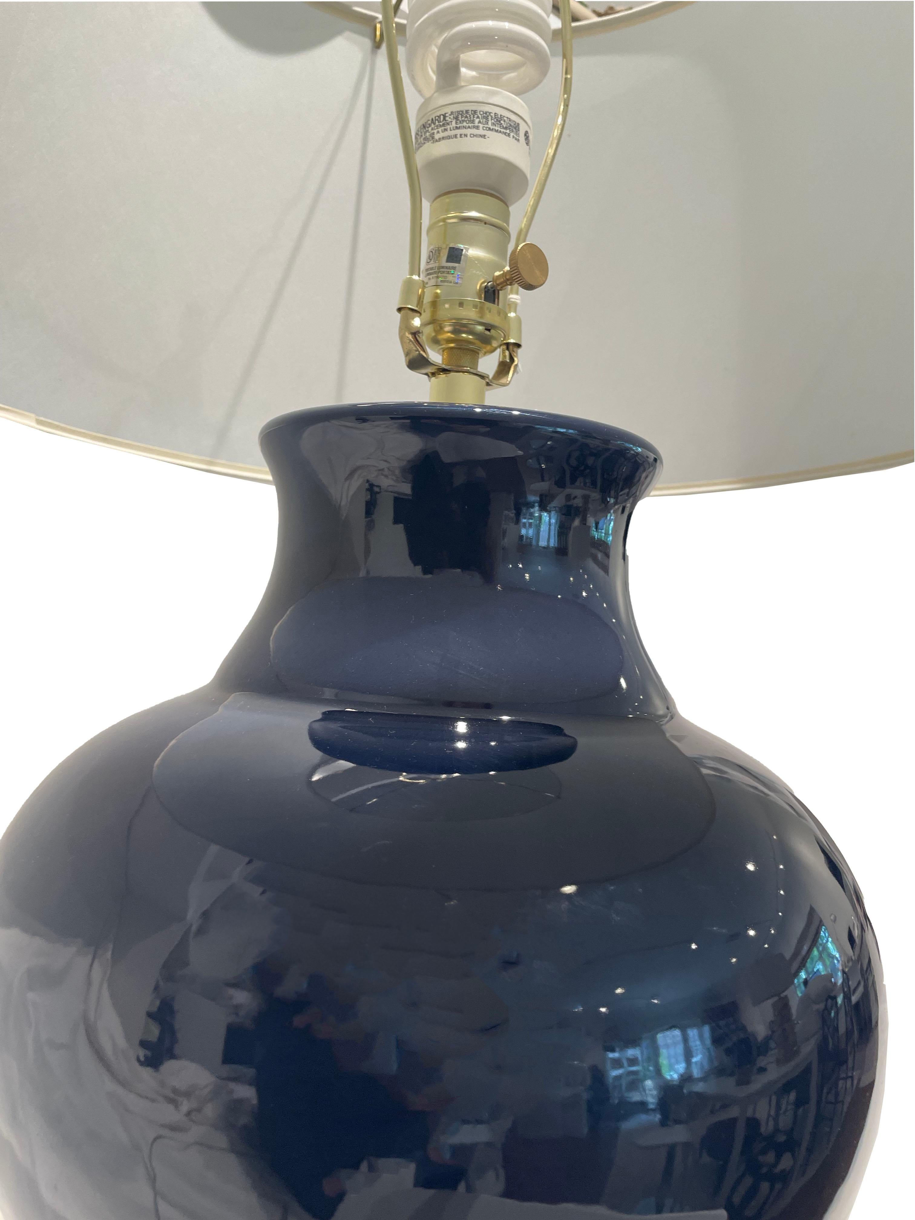 Beautiful and large scale navy blue ceramic lamps by designer Barbara Cosgrove. These lamps are discontinued and hard to find as the designer has stopped creating her lamps. The navy color is best represented in the single shot of the lamps.  It