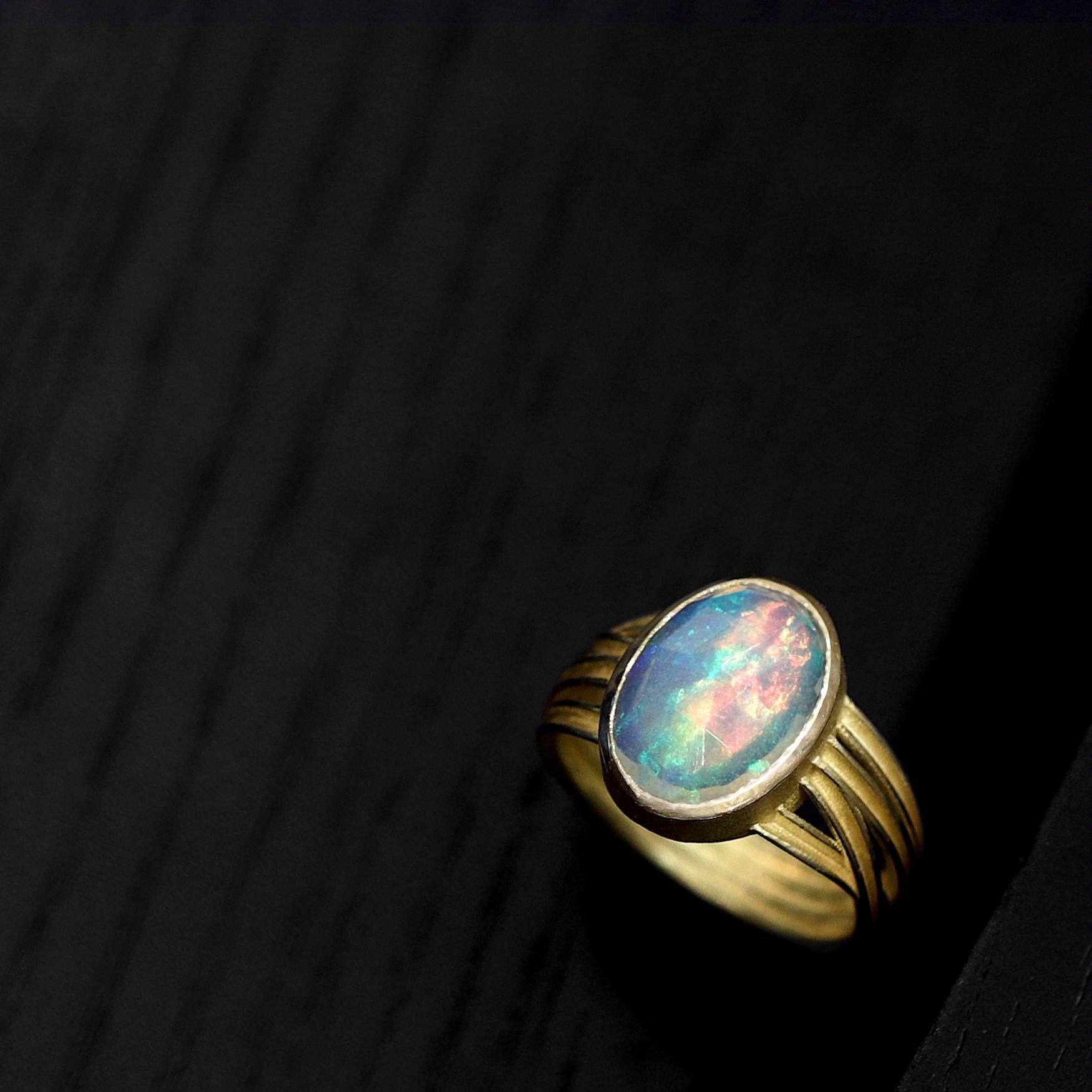 One of a Kind Multiwrap Band Ring hand-fabricated by master jewelry maker Barbara Heinrich showcasing an 2.89 carat rose-cut oval Ethiopian opal with brilliant rainbow color play and flash. The gorgeous gemstone rests in an 18k yellow gold bezel