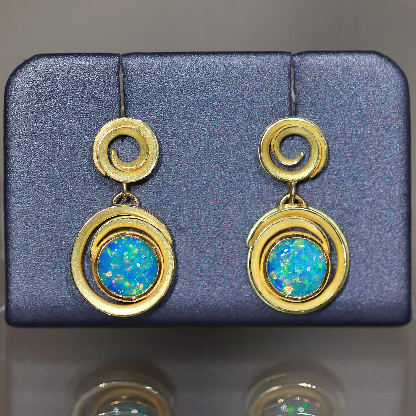 One of a Kind Double Swirl Drop Earrings hand-fabricated in signature-finished 18k yellow gold by award-winning jewelry maker Barbara Heinrich featuring a spectacular pair of top quality round vivid blue Australian opal doublet cabochons totaling