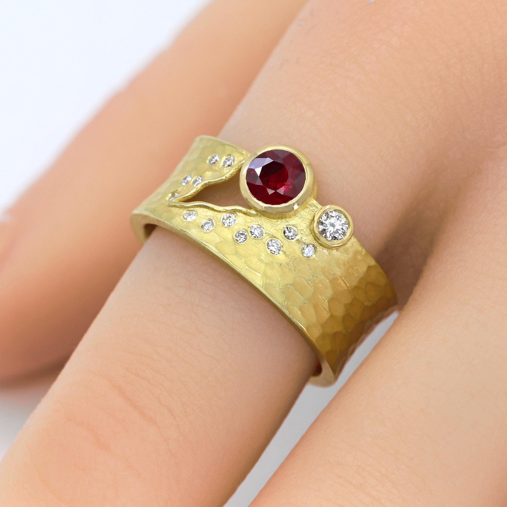 One of a Kind Carved Glacier Ring hand-fabricated by acclaimed jewelry maker Barbara Heinrich in finely-textured 18k yellow gold showcasing a gorgeous 0.47 carat round faceted ruby alongside a 0.05 carat round brilliant-cut white diamond and