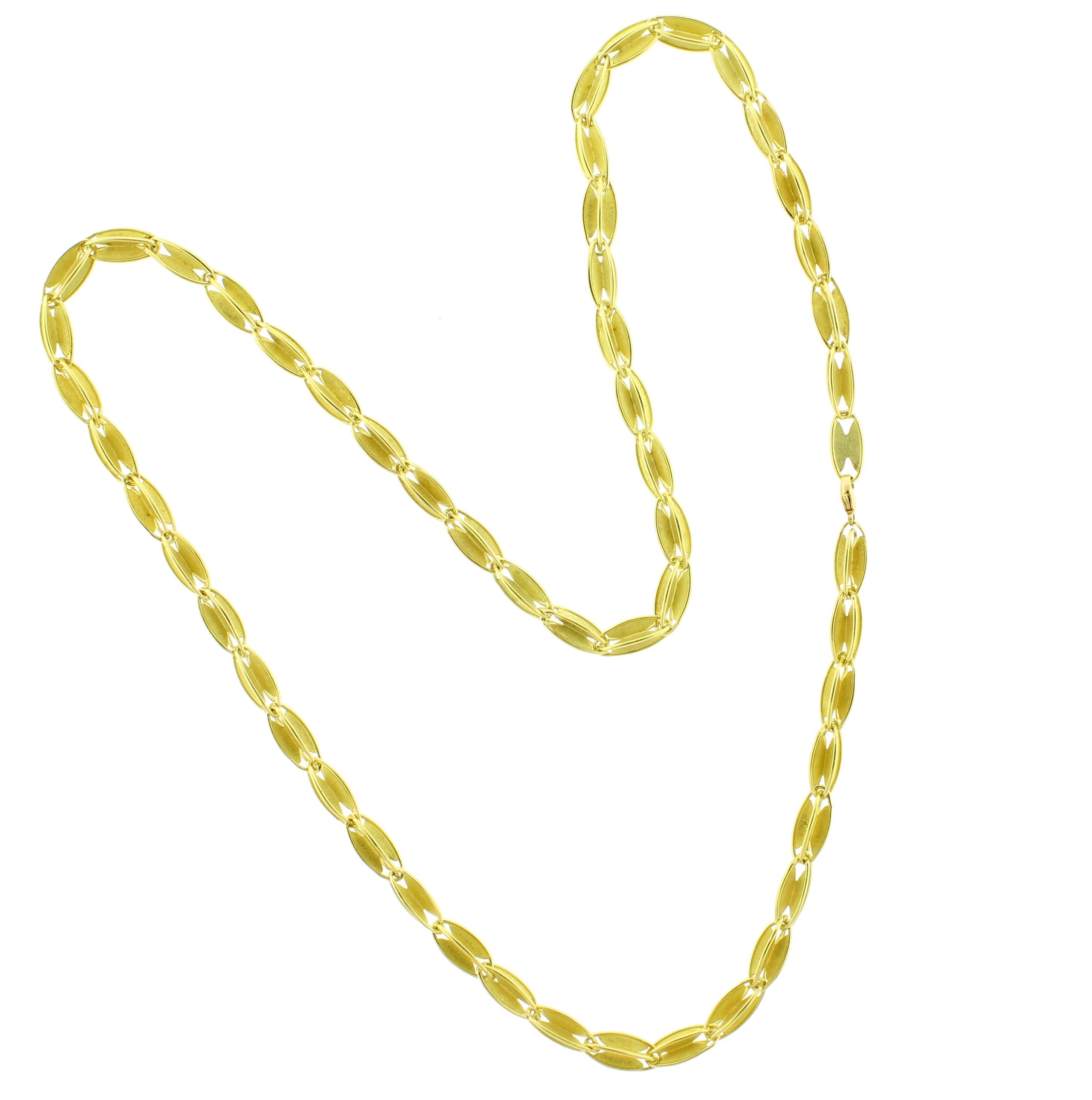 From the studios of classically trained goldsmith; Barbara Heinrich, a beautifully textured 18 karat gold necklace. The necklace features gold oval shaped links with highly polished edges measuring 24 inches and weighing 43.2 grams. Current retail