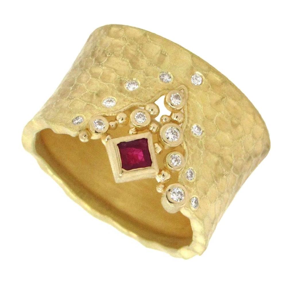 Wide carved glacier ring with a center v-shaped crevasse with one square cut ruby (0.12 carat) and scattered white diamonds (0.11ctw -15 stones) set in 18k yellow gold with a textured finish by Barbara Heinrich. 

Barbara Heinrich, a renowned