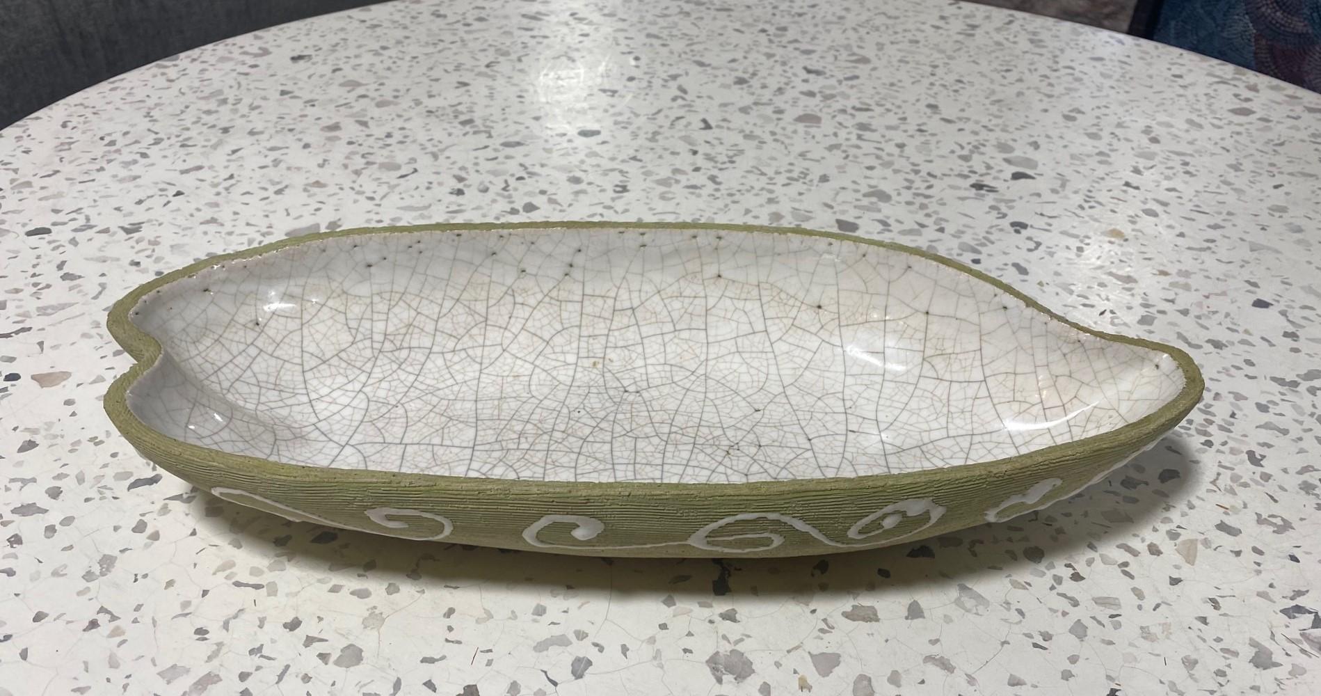 A beautifully designed and gorgeously glazed large stoneware Mid-century Modern low bowl by California studio pottery artist Barbara Willis (1917-2011).  The elongated curved contours and stunning white crackle glaze of this work are really quite