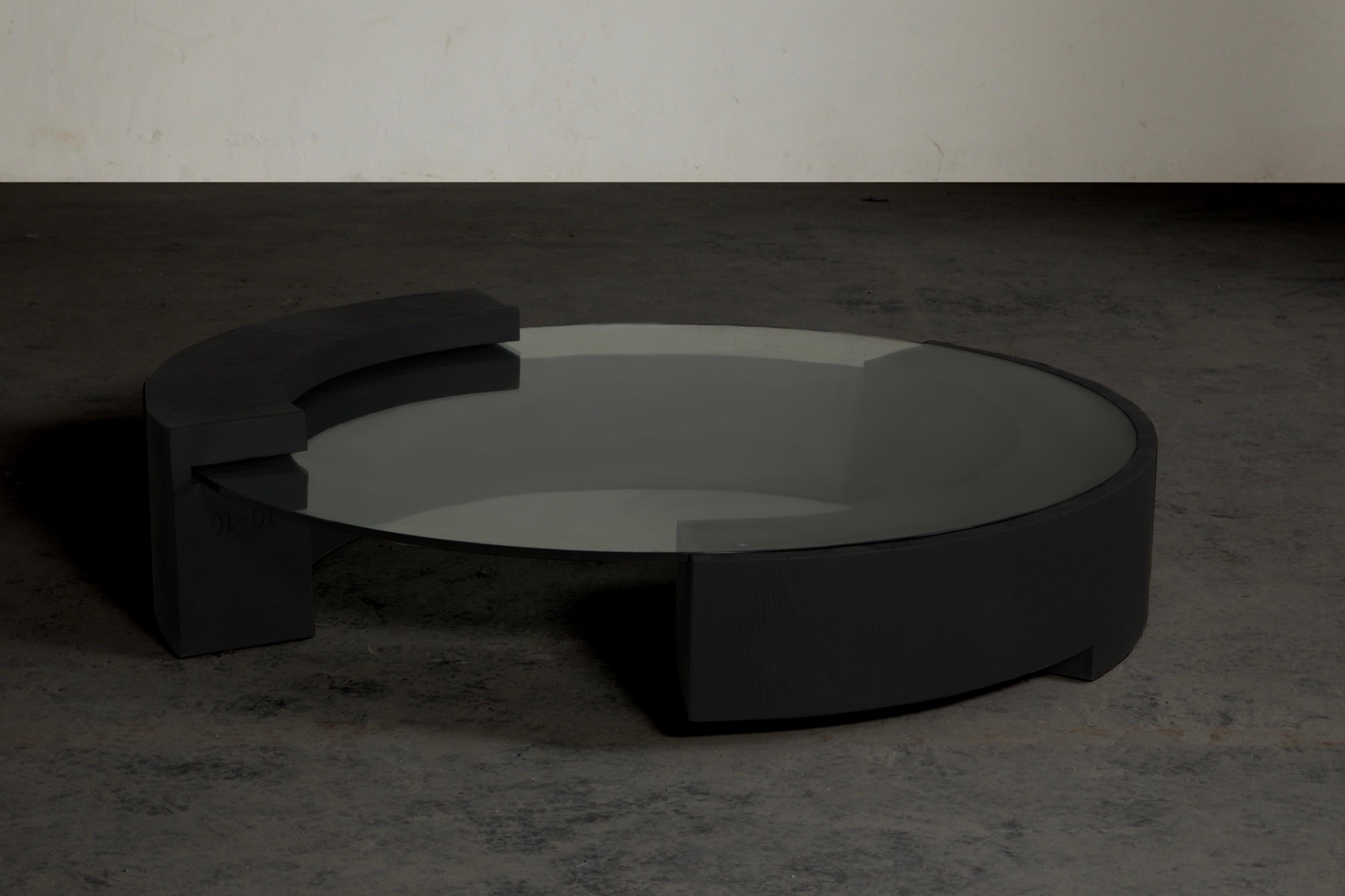 This cocktail table is designed by designers Diamant and Fu for Mirk Woo. In order to create retro avant-garde barbarism style furniture, solid wood carbonization and matte spray paint are used. The design inspiration comes from Roman Colosseum.