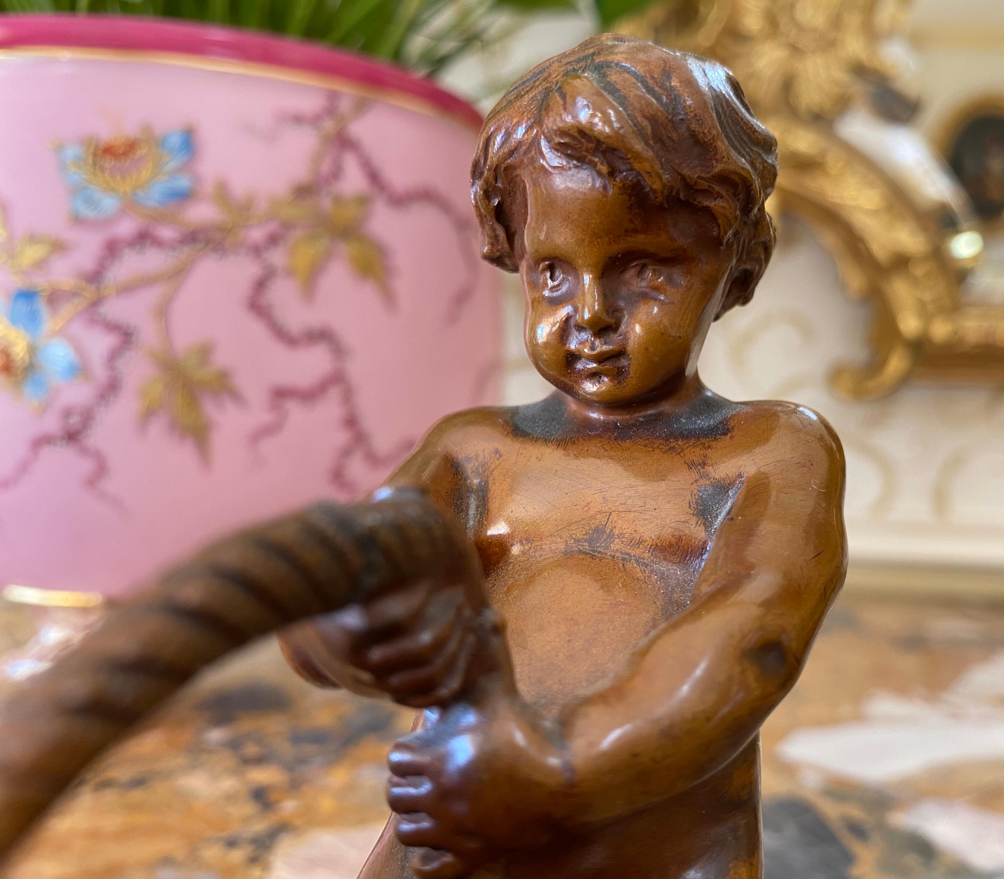 Small bronze representing a child holding a basket signed 