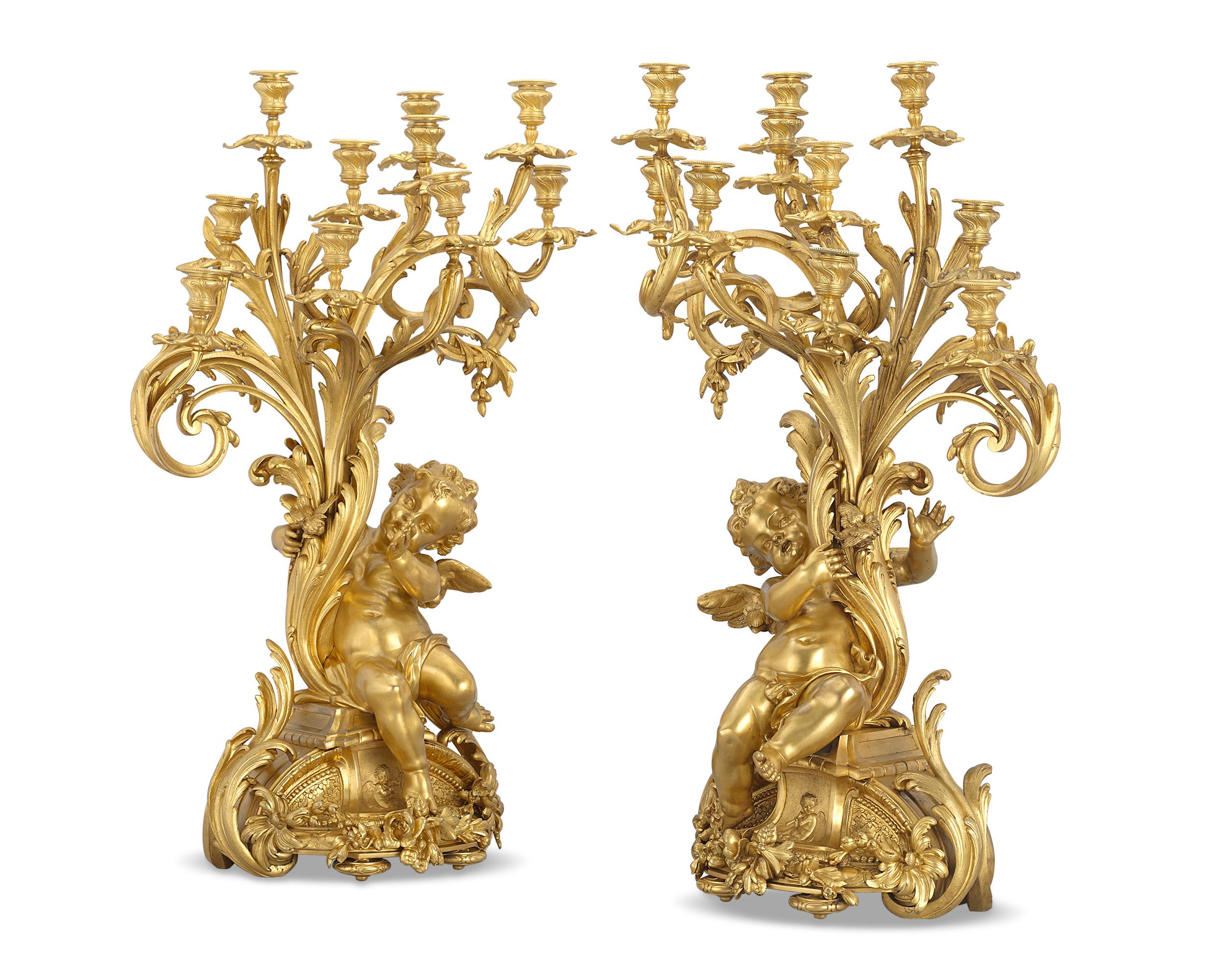 This rare and dramatic pair of Napoleon III gilt bronze candelabra were expertly cast and designed by the celebrated French bronzeur Ferdinand Barbedienne. Masterfully crafted, the candelabra are exemplary of the Rococo aesthetic. Organic swirls and