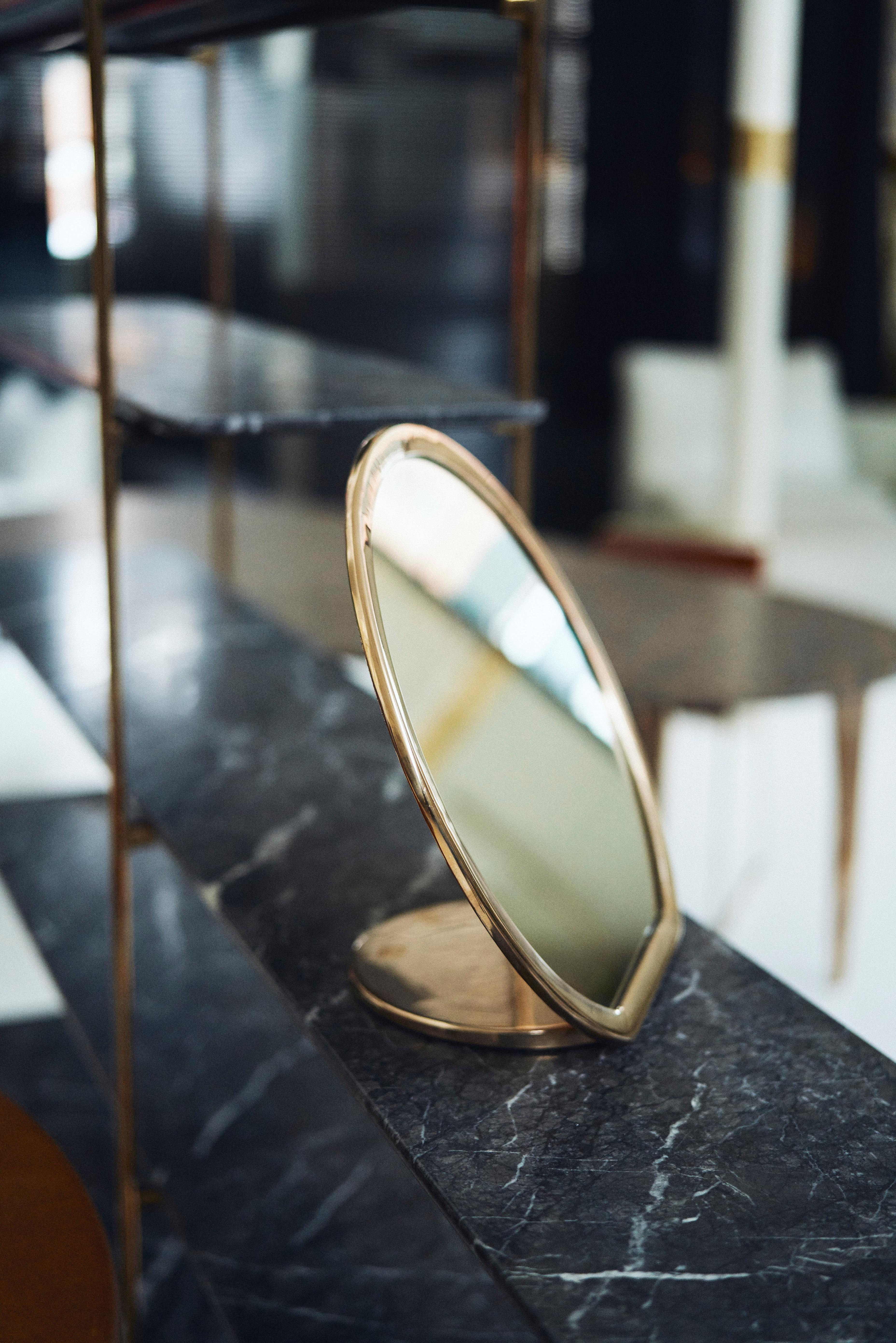 Designed by Daniel Barbera, the 'Bronze' make-up mirror is made from a sandcast solid bronze form that is hand finished to a smooth mirror polish, with the option of a satin or blackened bronze. Sculptural and minimal this mirror makes a create