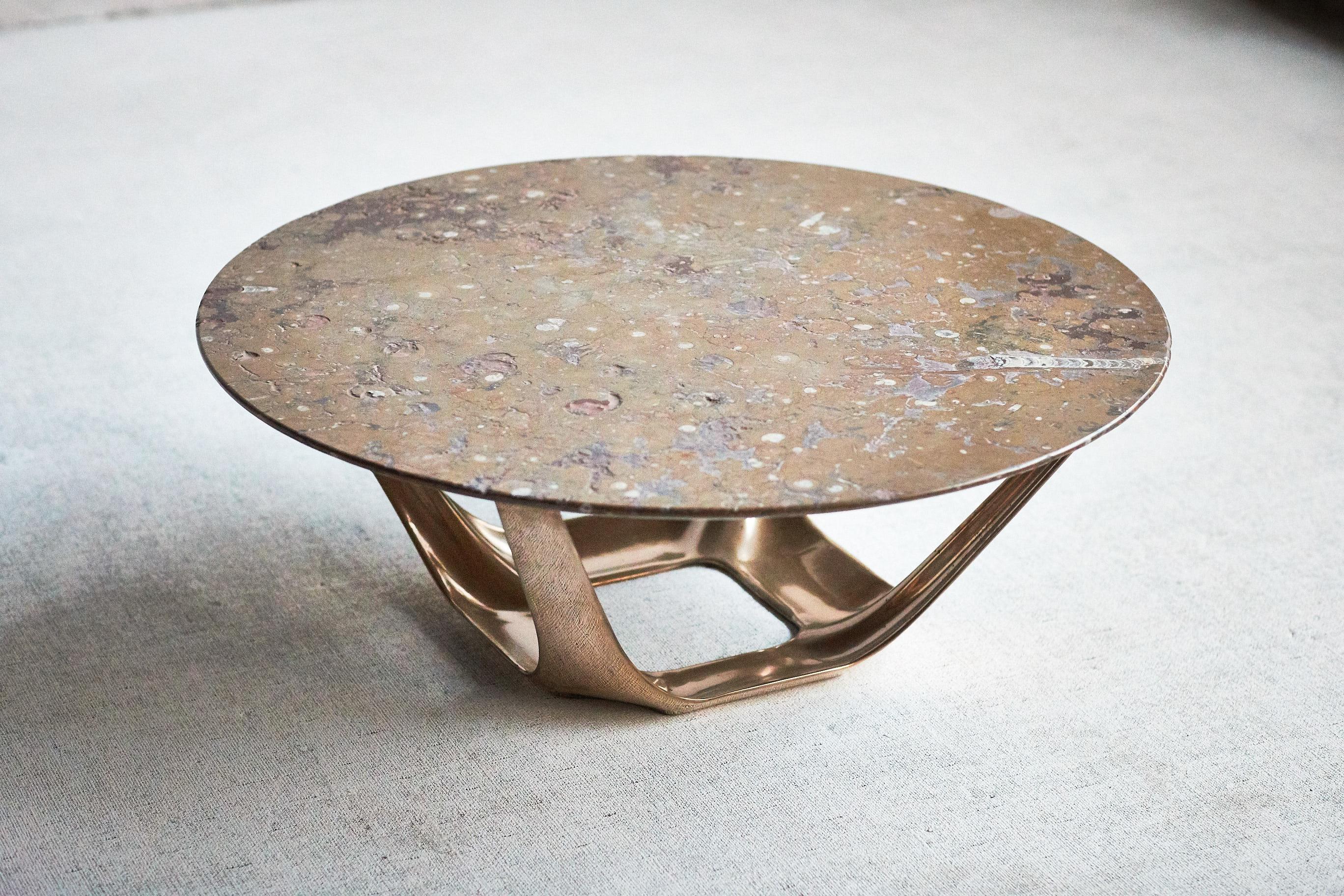 Designed by Daniel Barbera, the Heron coffee table, is a muscular sandcast solid bronze base with four organic forms rising from the base to support the top. The form is hand finished to a smooth mirror polish, with the option of a satin or
