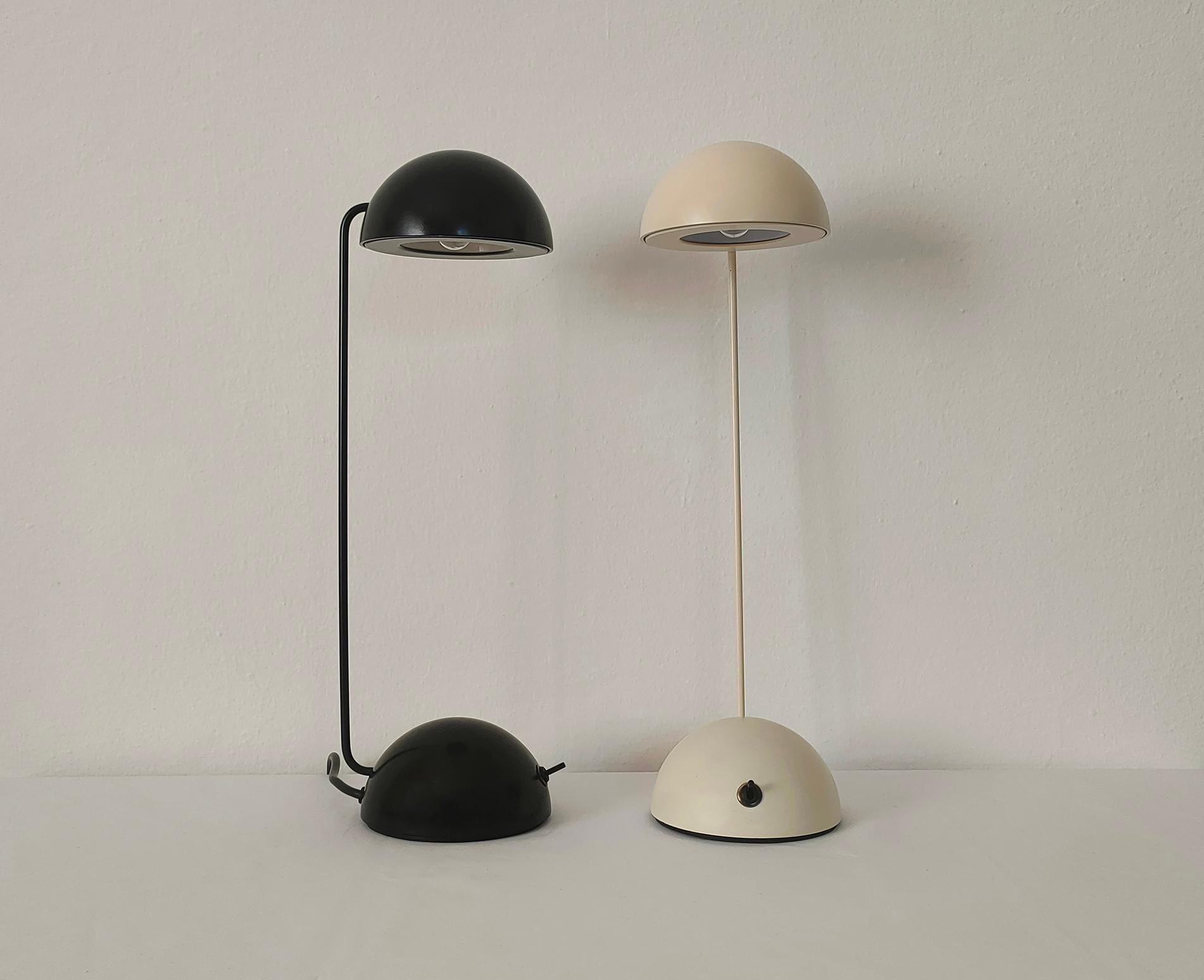 A pair of Minikini table lamps in white-cream enameled metal and in black enameled metal.
The Minikini is a lamp with a clean and refined design, highly versatile, and also with an adjustable stem and lampshade (they can assume different