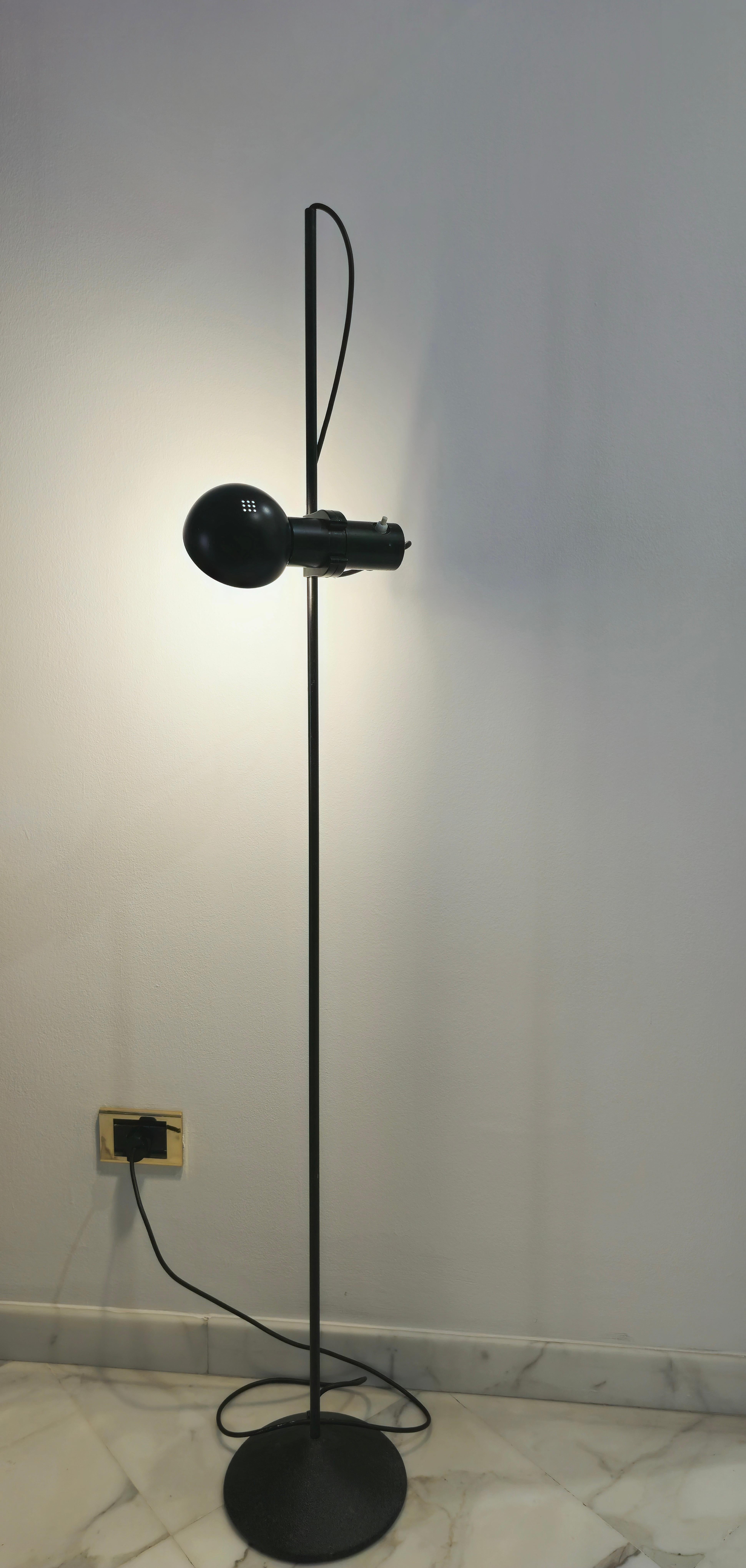Floor lamp produced in Italy 1960s. Black painted metal structure. Adjustable height, adjustable hemispherical diffuser, circular cone base.They keep every part in original. Perfectly functional.

Weight floor lamp: 4,400 Kg
Diffuser diameter: 11