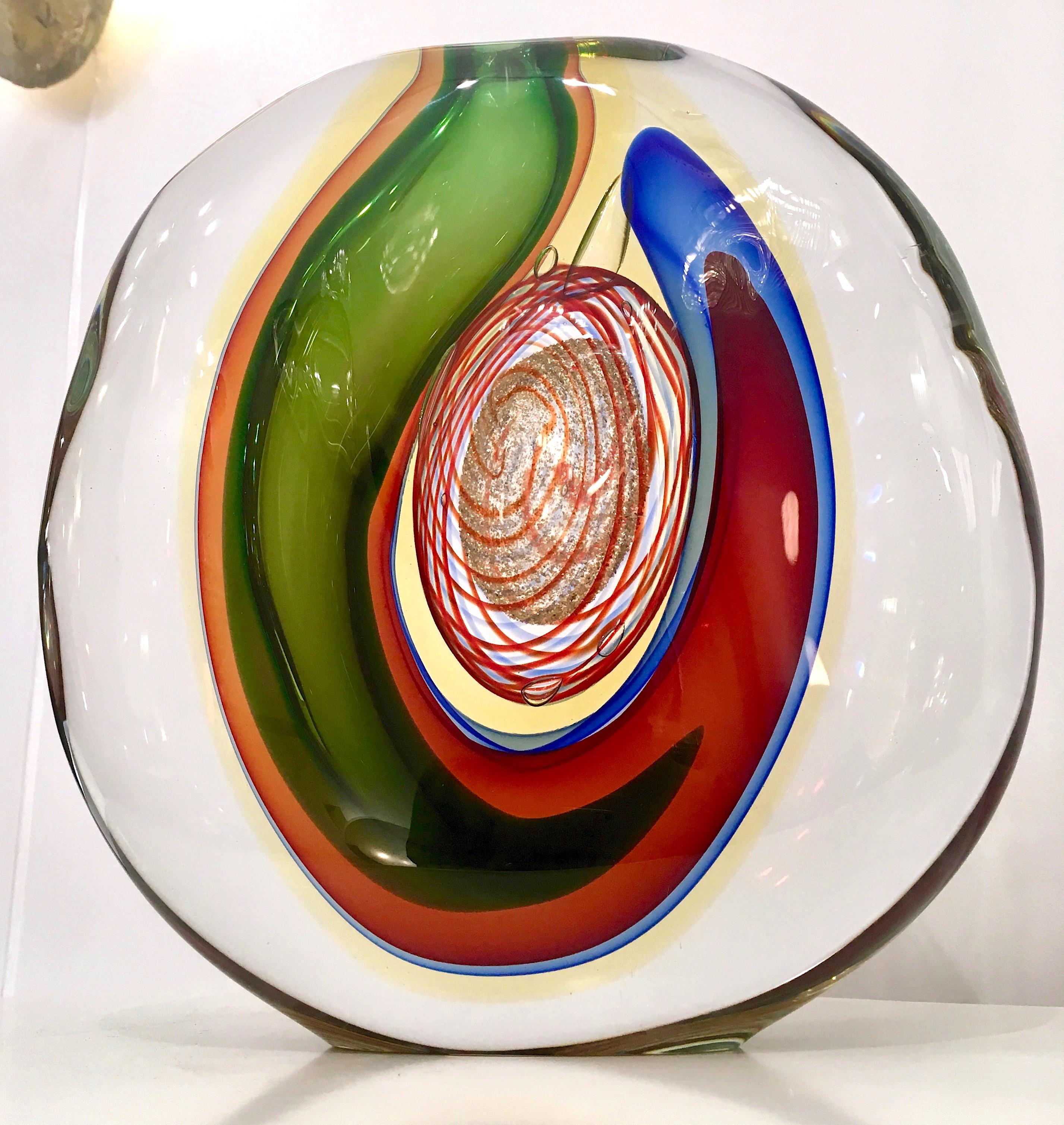 Sophisticated Italian work of Art by Alfredo Barbini, a sculptural vase of very organic stone shape, worked like an abstract painting, the crystal clear blown Murano glass encloses layers of Sommerso colors, blue, red, green, yellow and a precious