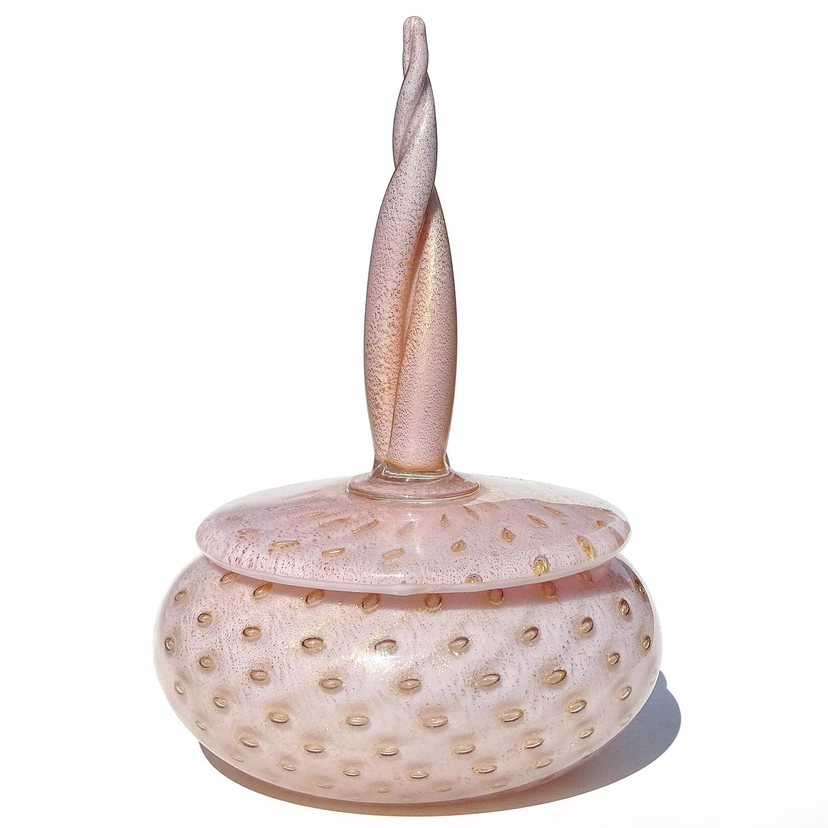 Beautiful vintage Murano hand blown pink, gold flecks and controlled bubbles Italian art glass powder / jewelry box. Documented to designer Alfredo Barbini, circa 1950s. The piece has a twisting spike top decoration. It is profusely covered in gold