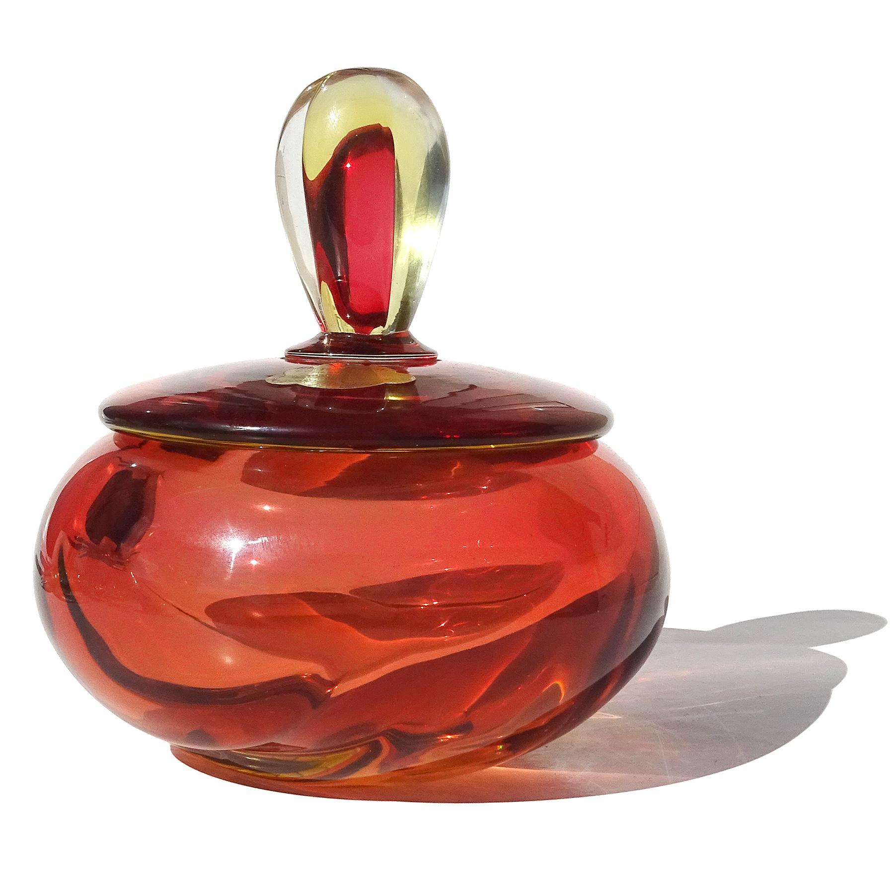 Beautiful vintage Murano hand blown Sommerso red orange, yellow and clear Italian art glass powder / jewelry box. Documented to designer Alfredo Barbini, circa 1950s. It is published in the Barbini catalog. The lid still has the original 