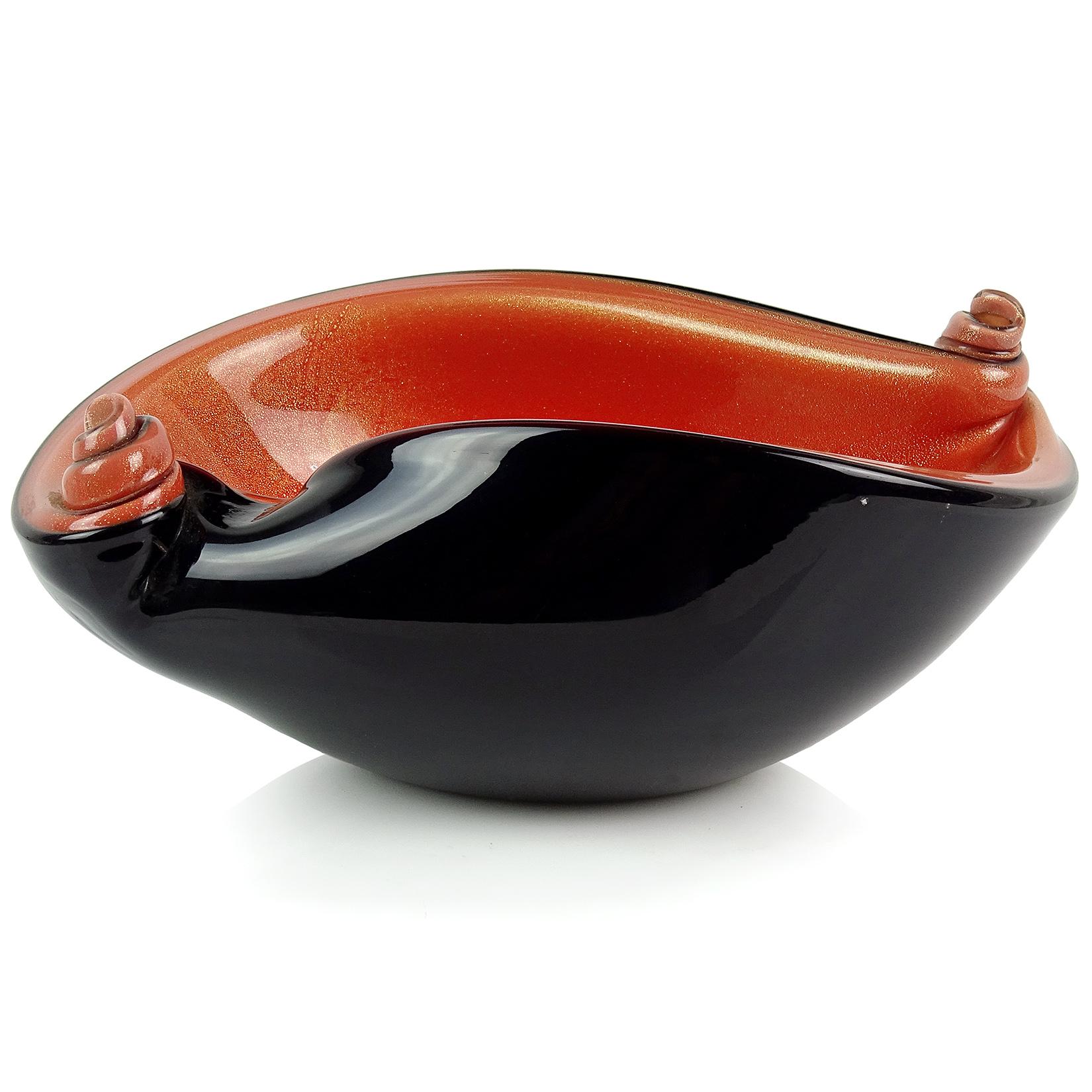 Beautiful vintage Murano hand blown black, persimmon orange and gold flecks Italian art glass scroll shell bowl. Documented to designer Alfredo Barbini, circa 1950s and published in his catalog. Great contrasting color combination and decorative