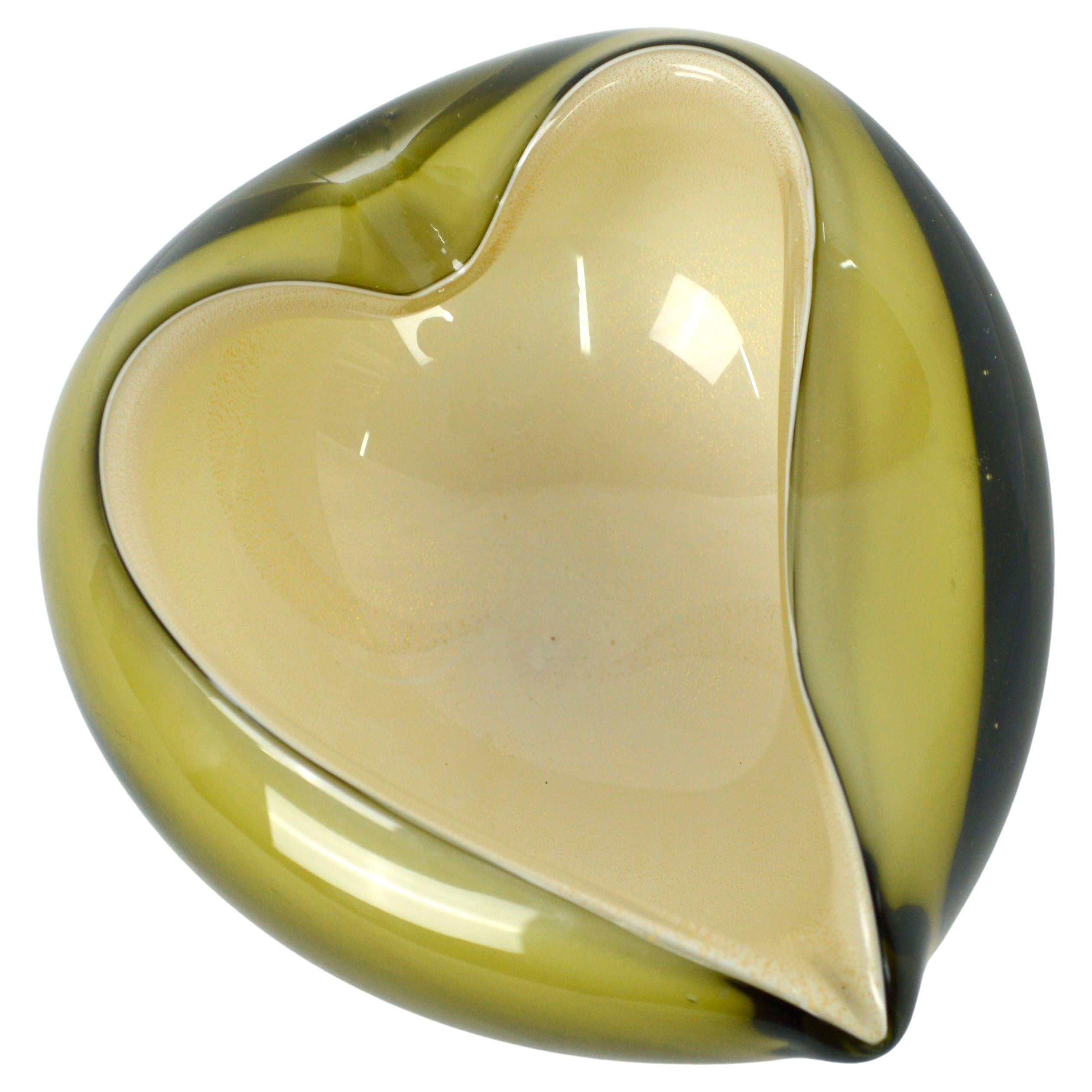 Elegant heart shaped two toned Murano glass bowl, with a transparent olive green/yellow ochre outer layer and an inner layer of gold-flecked cream, attributed to Alfredo Barbini (Italian, 1912-2007). This beautiful piece, which is typical of