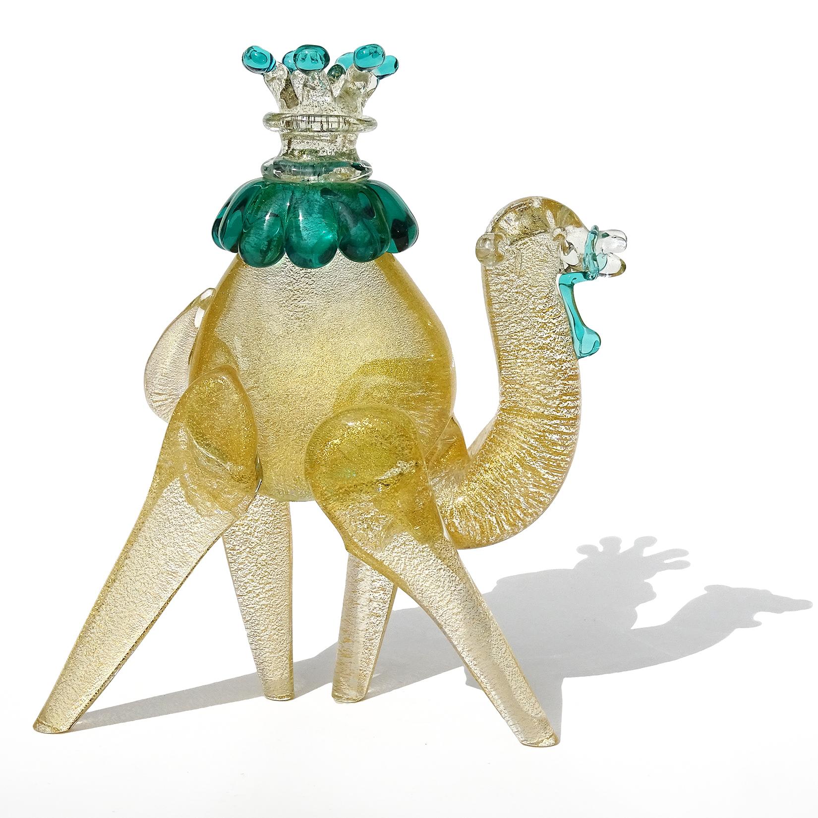 Beautiful and very unusual, vintage Murano hand blown clear and gold flecks Italian art glass camel sculpture / figurine. Attributed to designer Alfredo Barbini. The piece is profusely covered in gold leaf, with green details on the reins and seat