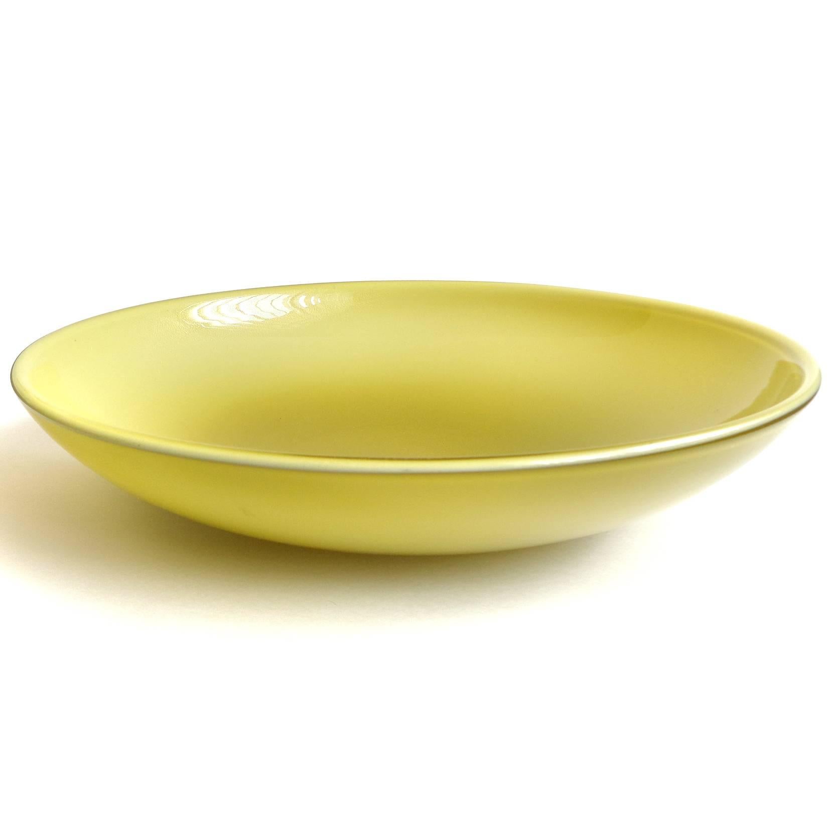 Beautiful large Murano hand blown yellow olive green with gold flecks Italian art glass centerpiece bowl. Attributed to designer Alfredo Barbini, circa 1950s. It is profusely covered in gold leaf on the top. Measures 12 1/2