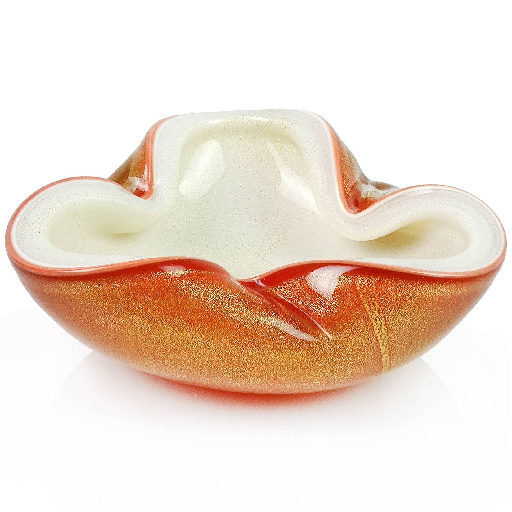 Beautiful vintage Murano hand blown orange over white and gold flecks Italian art glass bowl. Documented to Master glass artist and designer Alfredo Barbini, circa 1950-1960. Can be used as a display piece on any table. Use it as a catchall, or